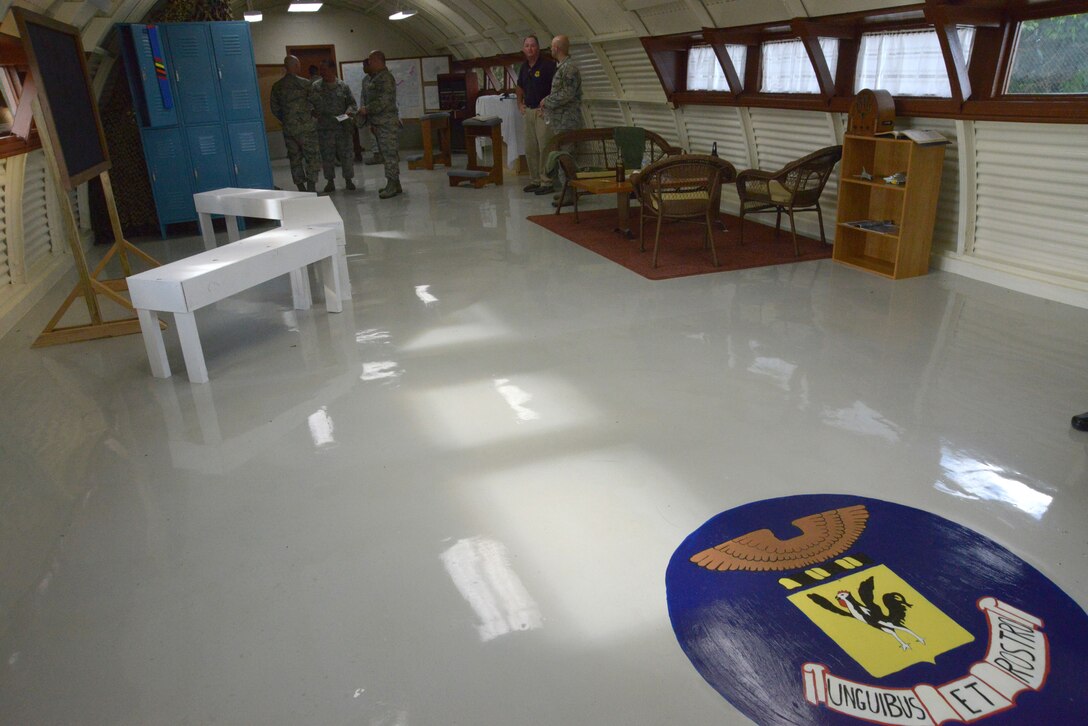 A seal bearing the 18th Wing's motto, "unguibus et rostro," meaning with beak and talon, or tooth and nail, decorates the entry way of the newly restored Quonset hut on Kadena Air Base, Japan.  This is the last standing Quonset hut on the air base. It has recently been restored by volunteers from the 18th Civil Engineer Squadron with the help of the 18th Wing History office and others on base. (U.S. Air Force photo by Tech. Sgt. Jocelyn Rich-Pendracki/Released)