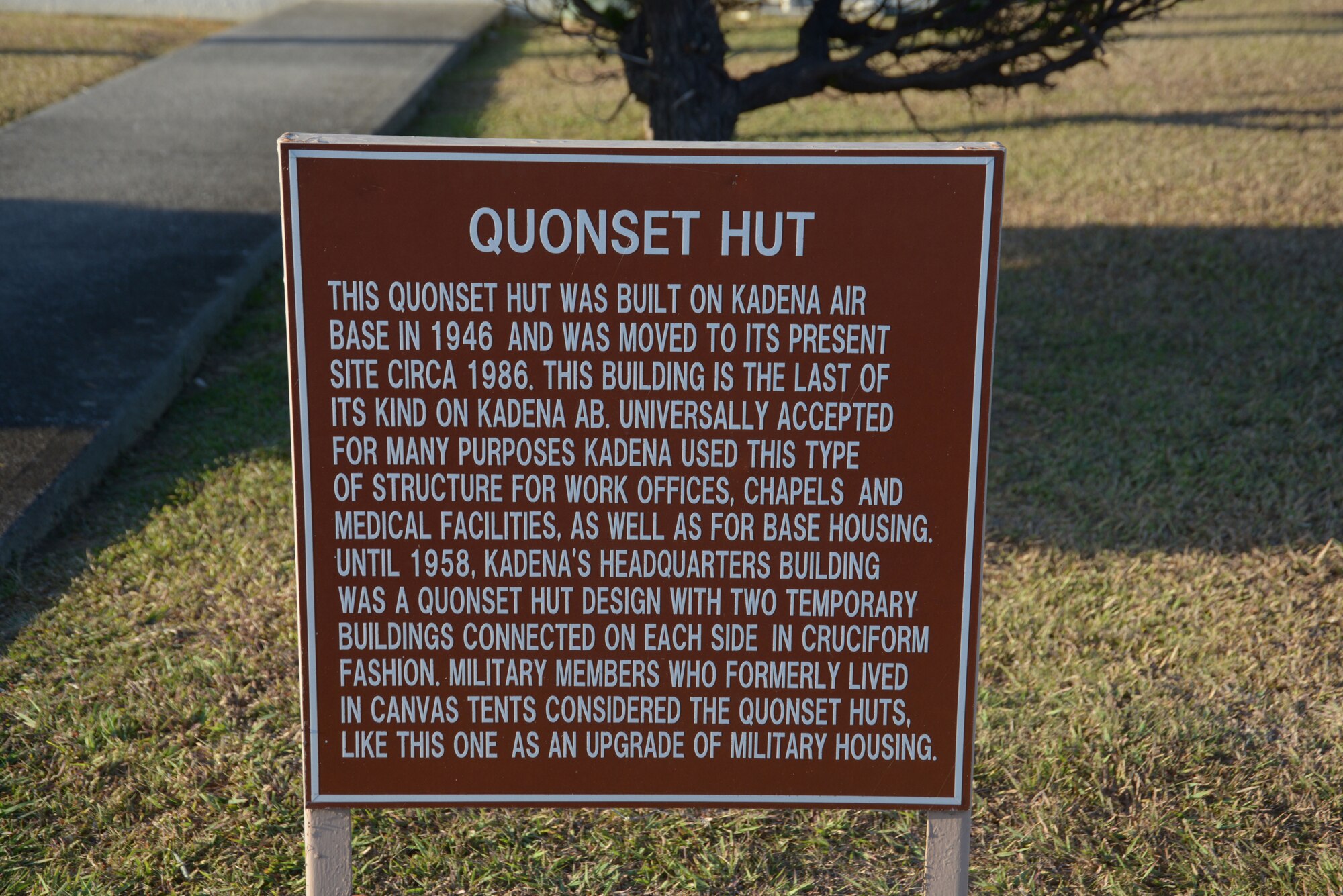 A sign rests outside the only remaining Quonset hut on Kadena Air Base, Japan. This hut was completely restored to give visitors an idea of what life was like during the days of Quonset hut use. (U.S. Air Force photo by Tech. Sgt. Jocelyn Rich-Pendracki/Released)