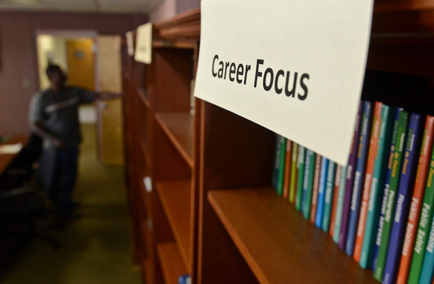 Senior Master Sgt. Clifton Washington, 2nd Aircraft Maintenance Squadron aircraft maintenance unit superintendent, searches for a book at the Airman and Family Readiness Center on Barksdale Air Force Base, La., Aug. 13, 2013. The A&FRC offers Airmen, retirees and dependents self-help books in several different categories such as career focus, financial, family life and relocation.  (U.S. Air Force photo/Senior Airman Micaiah Anthony)