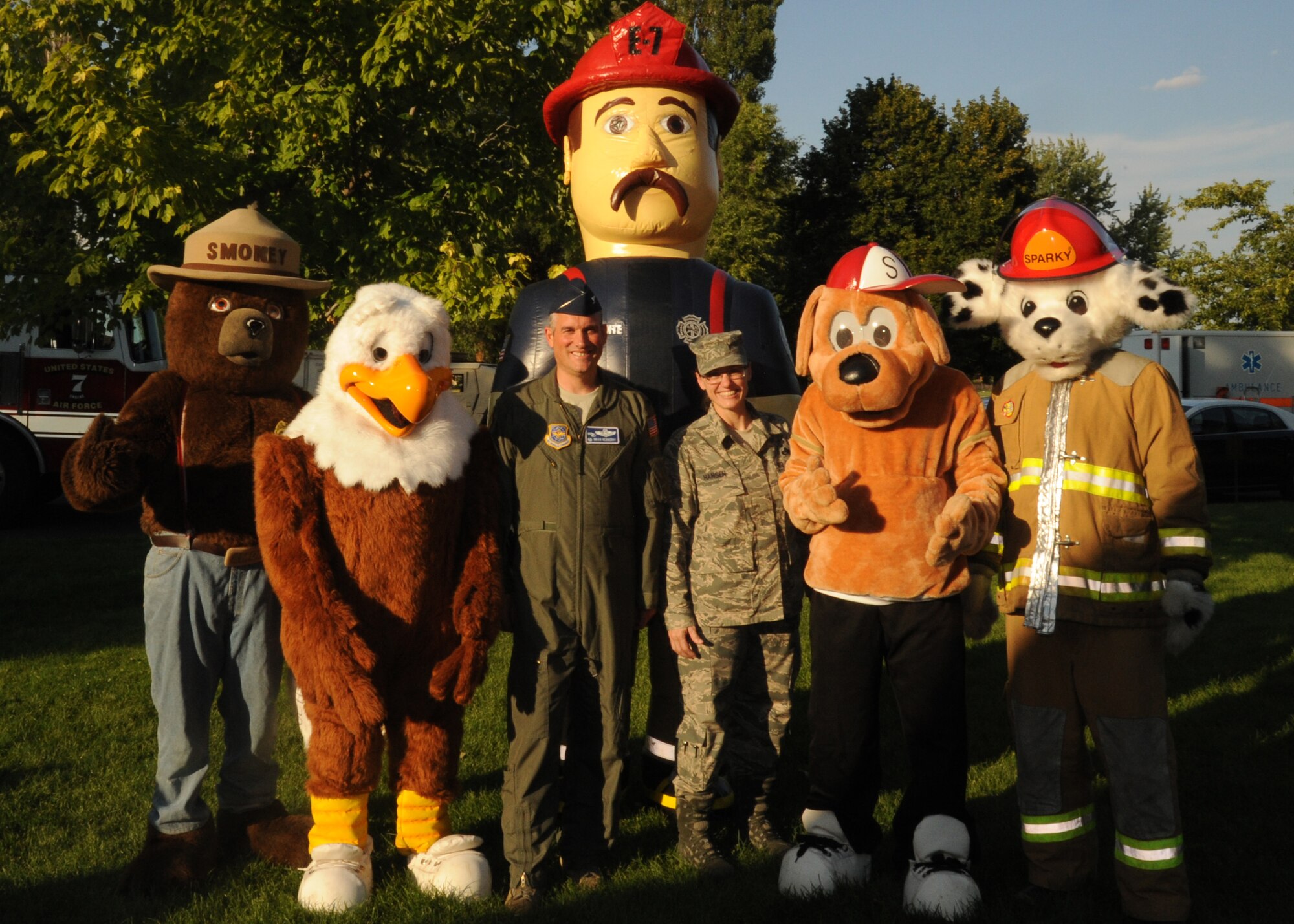 Col. Brian Newberry, 92nd Air Refueling Wing commander, and Chief Master Sgt. Wendy Hansen, 92nd Air Refueling Wing command chief, pose for a photo with mascots at Fairchild Air Force Base, Wash., Aug. 6, 2013.  The photo participants were on hand to celebrate the National Night Out at Miller Park.  (U.S. Air Force photo by Airman 1st Class Sam Fogleman/Released)