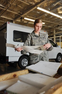 Senior Airman Amanda Diaz Canales, 28th Logistics Readiness Squadron traffic management technician, labels parts she received at the Packing and Crating Center before having them delivered to the appropriate shop on Air Force Base, S.D. Aug. 8, 2013. Airmen at Packing and Crating are responsible for receiving shipments, taking accountability, and delivering parts to specific shops, ensuring timely distribution of parts increasing mission effectiveness. (U.S. Air Force photo by Airman 1st Class Rebecca Imwalle/Released)