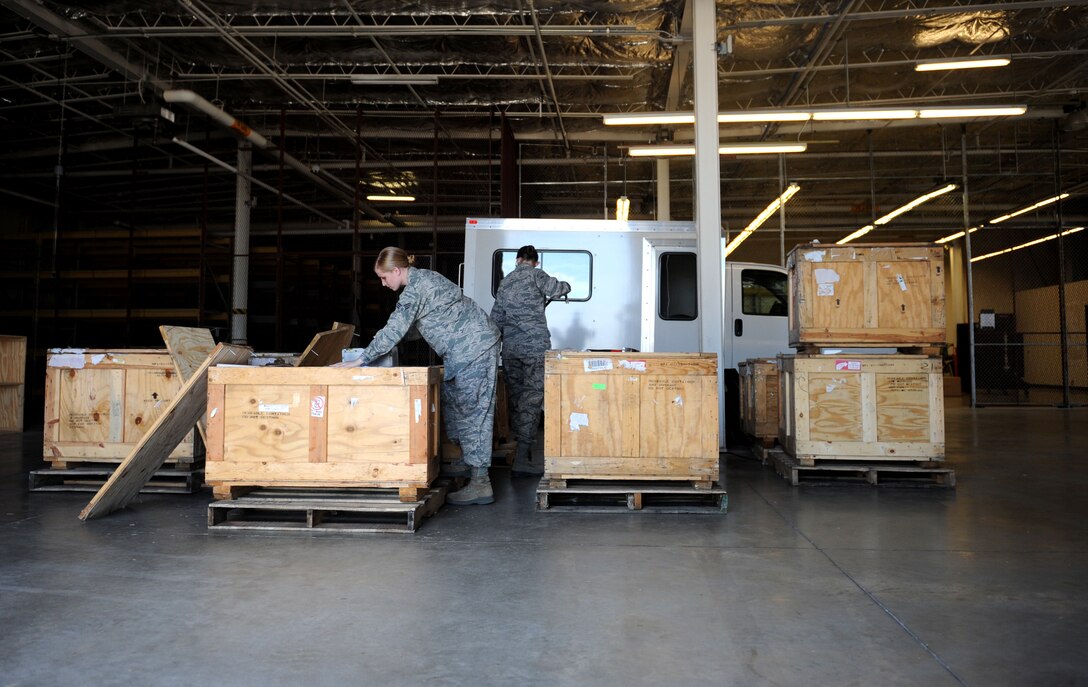 Senior Airman Amanda Diaz Canales and Airman 1st Class Chelsea Shields, 28th Logistics Readiness Squadron traffic management technicians, take accountability of received parts at the Packing and Crating Receiving Center on Ellsworth Air Force Base, S.D. Aug. 8, 2013. Technicians use a computer system to keep track of all the assets they receive and the financial transactions associated with them. (U.S. Air Force photo by Airman 1st Class Rebecca Imwalle/Released)