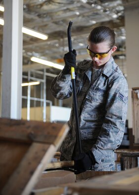Airman 1st Class Chelsea Shields, 28th Logistics Readiness Squadron traffic management technician, opens a crate at the Packing and Crating Receiving Center on Ellsworth Air Force Base, S.D. Aug. 8, 2013. Packing and Crating receives multiple shipments a day which aids in supplying maintenance Airmen with the parts they need to keep the B-1 bombers mission ready. (U.S. Air Force photo by Airman 1st Class Rebecca Imwalle/Released)
