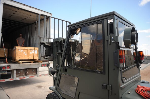Senior Airman Timothy Hunter, 28th Logistics Readiness Squadron traffic management technician, receives a shipment of aircraft parts while operating a forklift at the Packing and Crating Receiving Center on Ellsworth Air Force Base, S.D. Aug. 8, 2013. The receiving center handles and distributes an average of 1,000 parts per month, varying from small screws to aircraft wings. (U.S. Air Force photo by Airman 1st Class Rebecca Imwalle/Released)