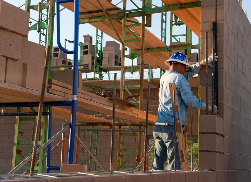 A worker from a contracting company builds the walls of the new firing range Aug. 12, 2013, at Dyess Air Force Base, Texas. The $4.5 million renovation is one of the many projects that the 7th Contracting Squadron oversees. (U.S. Air Force photo by Airman Autumn Velez/Released)