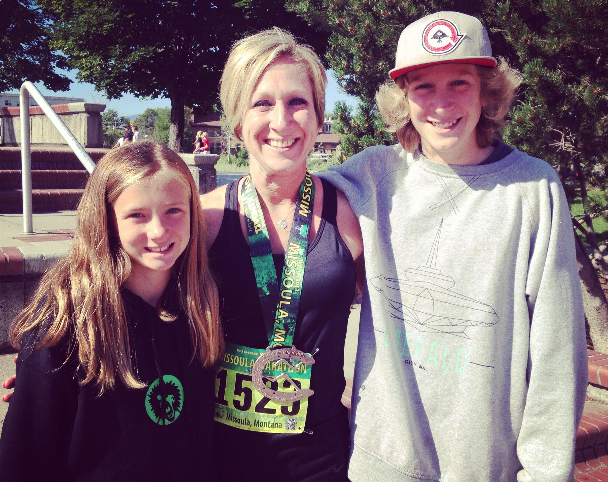 Tech. Sgt. Tracy Trosine, 92nd Logistics Readiness Squadron equipment accountability element NCO in charge, poses for a photo with her children Katelyn and Noah after the Missoula Marathon in Missoula, Mont., July 14, 2013. Trosine will run the Heartland 100 Spirit of the Prairie, a road race in Cassody, Kan., to raise money for the Wounded Warrior Program in Oct. (Courtesy Photo)