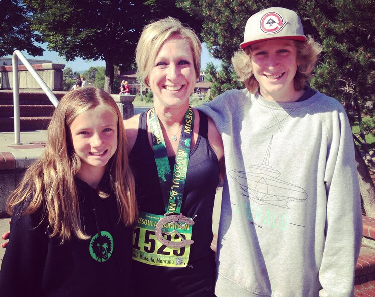 Tech. Sgt. Stacy Trosine, 92nd Logistics Readiness Squadron equipment accountability element NCO in charge, poses for a photo with her children Katelyn and Noah after the Missoula Marathon in Missoula, Mont., July 14, 2013. Trosine will run the Heartland 100 Spirit of the Prairie, a road race in Cassody, Kan., to raise money for the Wounded Warrior Program in Oct. (Courtesy Photo)