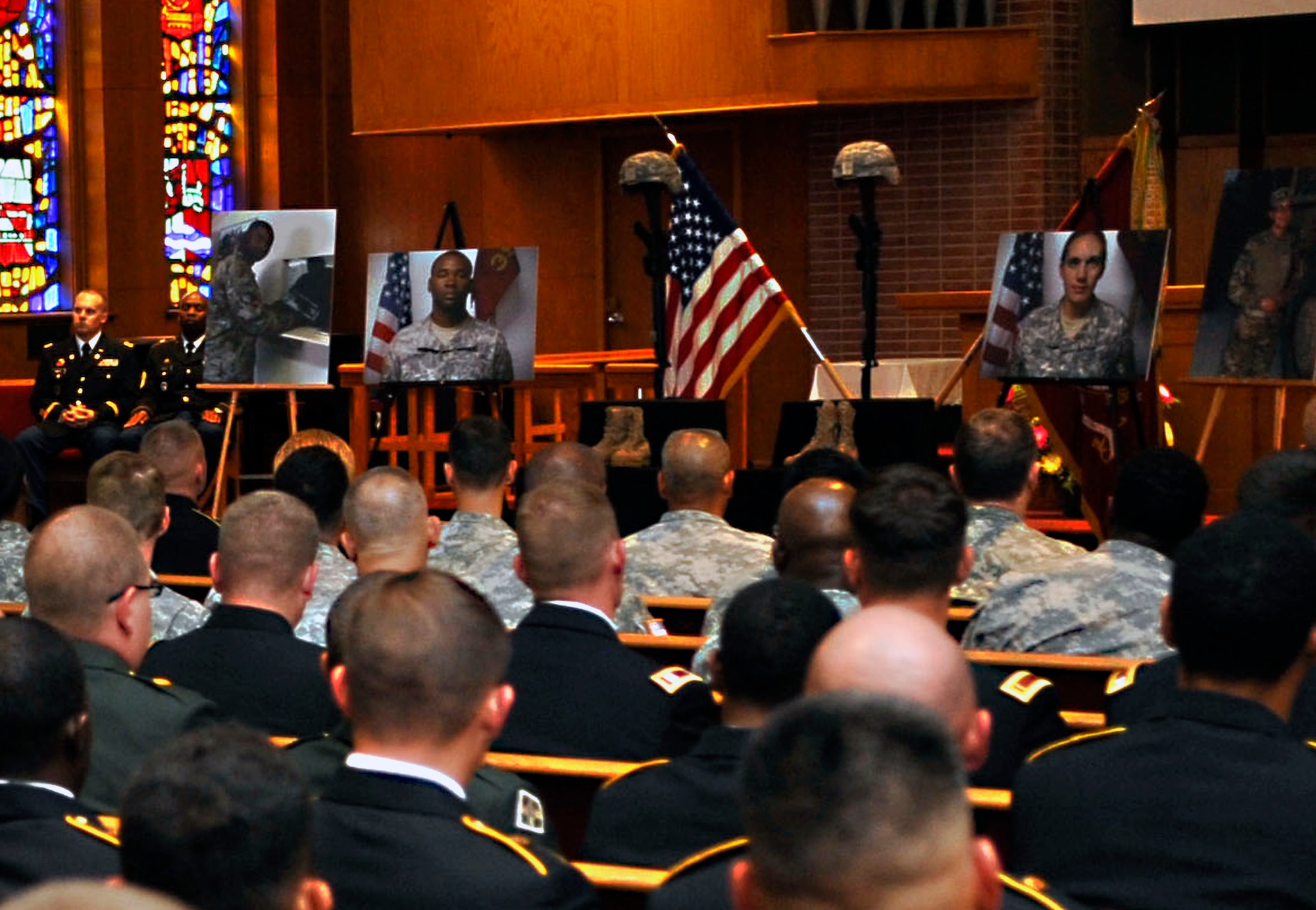 Members of the 359th Inland Cargo Transfer Company, 10th Transportation Battalion, gather for a memorial service honoring the memory of 7th Sustainment Brigade Soldiers Staff Sgt. Eric Lawson and Sgt. Caryn Nouv, Aug. 13, 2013, at Fort Eustis, Va. Both Lawson and Nouv were killed July 27, 2013, in Ghanzi Province, Afghanistan when enemy forces attacked their vehicle with an improvised explosive device and small-arms fire. (U.S. Air Force photo by Staff Sgt. Wesley Farnsworth/Released)