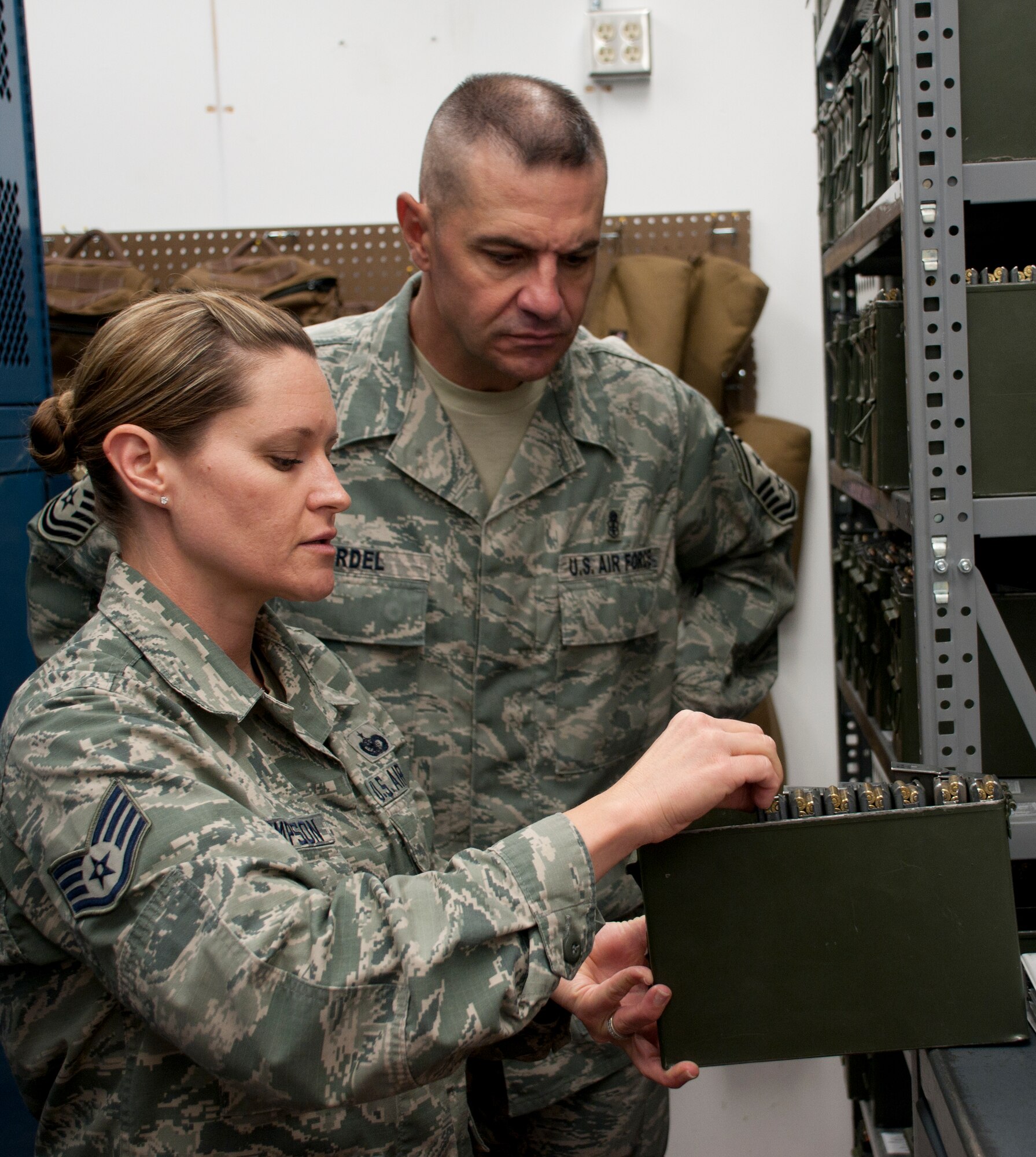 130808-F-BR137-084
Staff Sgt. Megan Thompson, 90th Security Forces Group Tactical Response Force Combat Arms Training and Maintenance NCO-in-charge, shows Chief Master Sgt. David Nordel, 20th Air Force command chief, how the TRF stores ammunition in the TRF armory Aug. 8, 2013. Nordel’s tour of 90th SFG facilities focused partly on weapons safety. The container shown contains 5.56 mm ball tracer rounds, 9 mm hollow-point rounds and M-84 stun grenades. (U.S. Air Force photo by Airman 1st Class Jason Wiese) 
