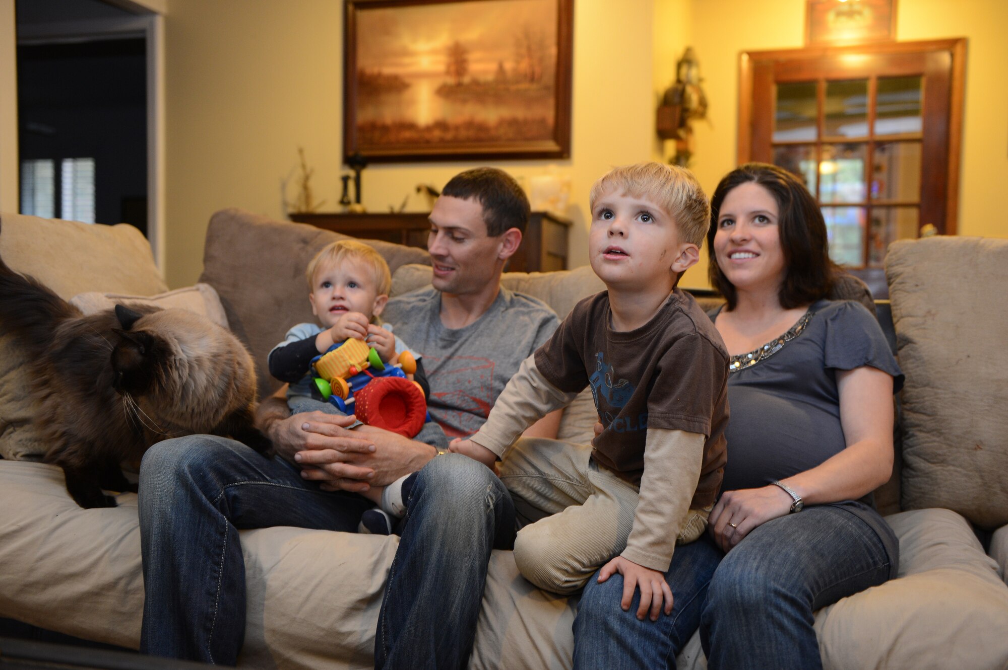 Tech. Sgt. Christian Bird (left) and Staff Sgt. Shelby Bird, sit with their sons Riordan (left) and Tiernan and their cat Tucker, in Wedgefield S.C., Nov. 11, 2012. Christian is the NCO in charge of the network operations security center at U.S. Air Forces Central, and Shelby is an Airman Leadership School instructor with the 20th Force Support Squadron. (U.S. Air Force photo by Airman 1st Class Daniel Blackwell/Released)