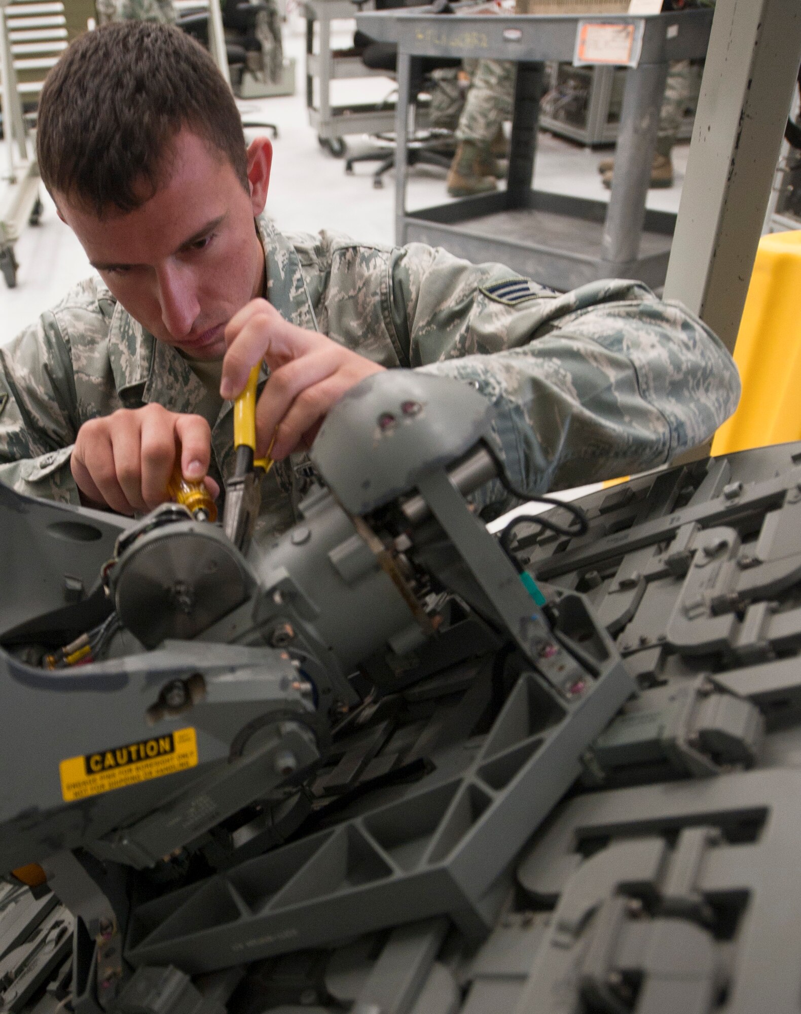 Senior Airman Nicholas Siegler, 1st Special Operations Component Maintenance Squadron mission systems journeyman, works on an APQ- 180 radar strike at the 1st CMS on Hurlburt Field, Fla., Aug. 7, 2013. The APQ-180 radar strike antenna is multipurpose radar for the AC-130U Spooky gunship. (U.S. Air Force photo by Senior Airman Krystal M. Garrett)