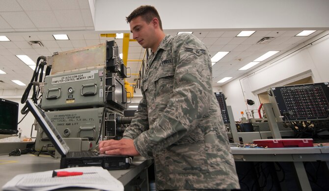 Airman 1st Class Zachary Barkley, 1st Special Operations Component Maintenance Squadron mission systems journeyman, looks over a technical order prior to working on equipment at the 1st SOCMS on Hurlburt Field, Fla., Aug. 7, 2013. Technical orders are step-by-step instructions which guide Airmen on how to repair equipment. (U.S. Air Force photo by Senior Airman Krystal M. Garrett) 