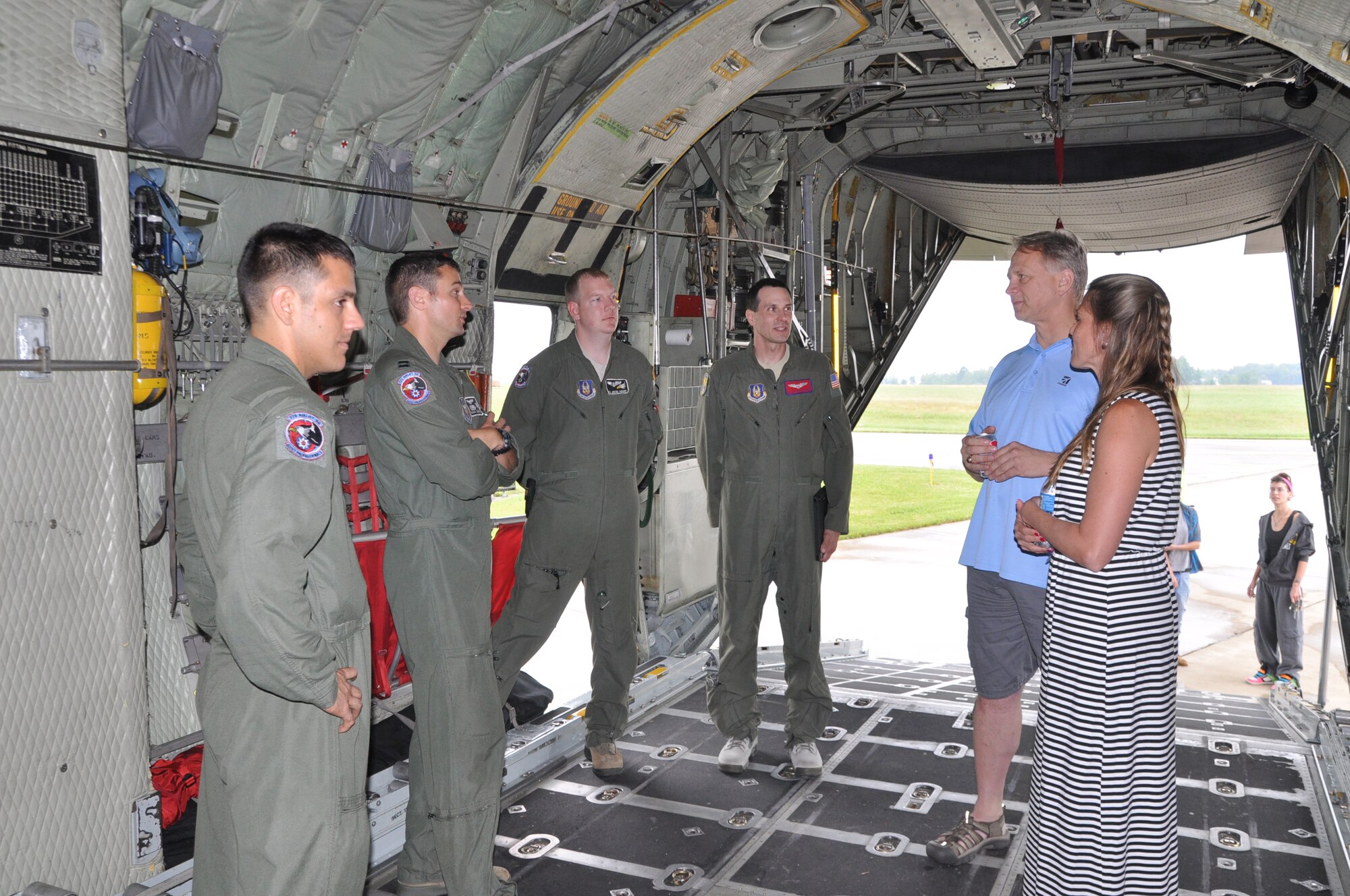 VIENNA, Ohio – A group of Air Force Reserve Citizen Airmen, assigned to the 910th Operations Support Squadron, based at adjacent Youngstown Air Reserve Station (YARS), Ohio, stand in the cargo deck of a C-130 Hercules cargo aircraft and talk with attendees of a Fly-In hosted by Winner Aviation, the Fixed Base Operator at Youngstown-Warren Regional Airport (YNG), here, July 27, 2013. The C-130, also based at YARS, was a static display as part of the event. U.S. Air Force photo by Master Sgt. Bob Barko Jr. 