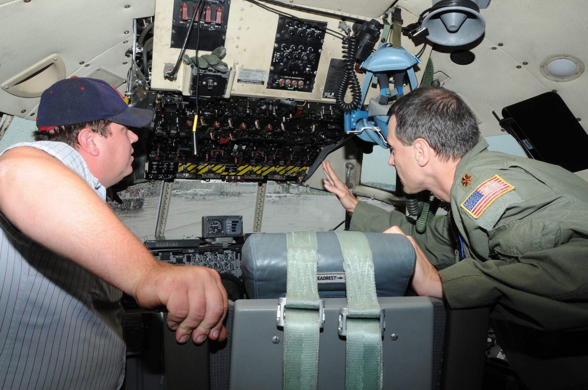 VIENNA, Ohio – Air Force Reserve Maj. David Marcinski, a co-pilot assigned to the 910th Operations Support Squadron, based at adjacent Youngstown Air Reserve Station (YARS), Ohio, shows the flight engineer control panel on the flight deck of C-130 Hercules cargo aircraft to an attendee of a Fly-In hosted by Winner Aviation, the Fixed Base Operator at Youngstown-Warren Regional Airport (YNG), here, July 27, 2013. The C-130, also based at YARS, was a static display as part of the event. U.S. Air Force photo by Sr. Airman Rachel Kocin