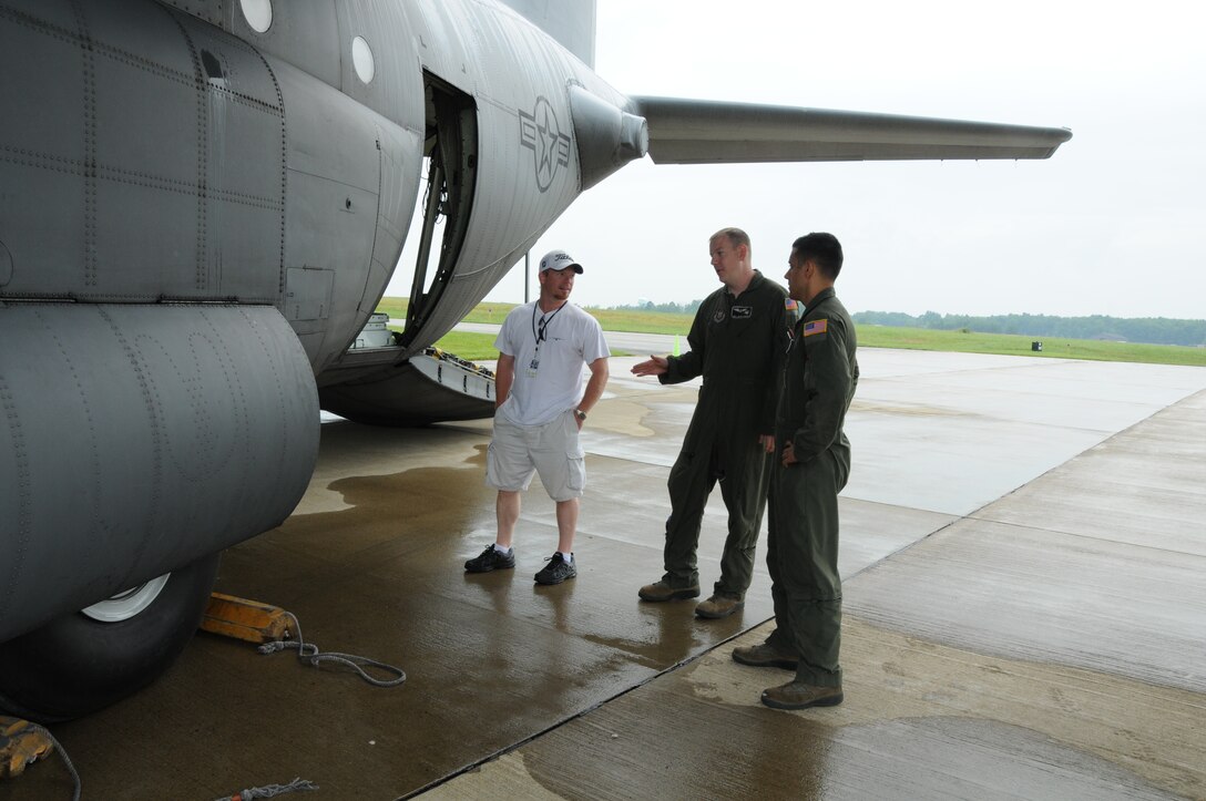 VIENNA, Ohio – Air Force Reserve Sr. Airman Jerod Indorf (center), a flight engineer assigned to the 910th Airlift Wing’s 773rd Airlift Squadron, based at adjacent Youngstown Air Reserve Station (YARS), Ohio, and Sr. Airman Jon Hardesty (right), a loadmaster also assigned to the 773rd, talk with an attendee of a Fly-In hosted by Winner Aviation, the Fixed Base Operator at Youngstown-Warren Regional Airport (YNG), here, July 27, 2013. The group stands near the rear of a C-130 Hercules cargo aircraft, also based at YARS, that was a static display as part of the event. U.S. Air Force photo by Sr. Airman Rachel Kocin 