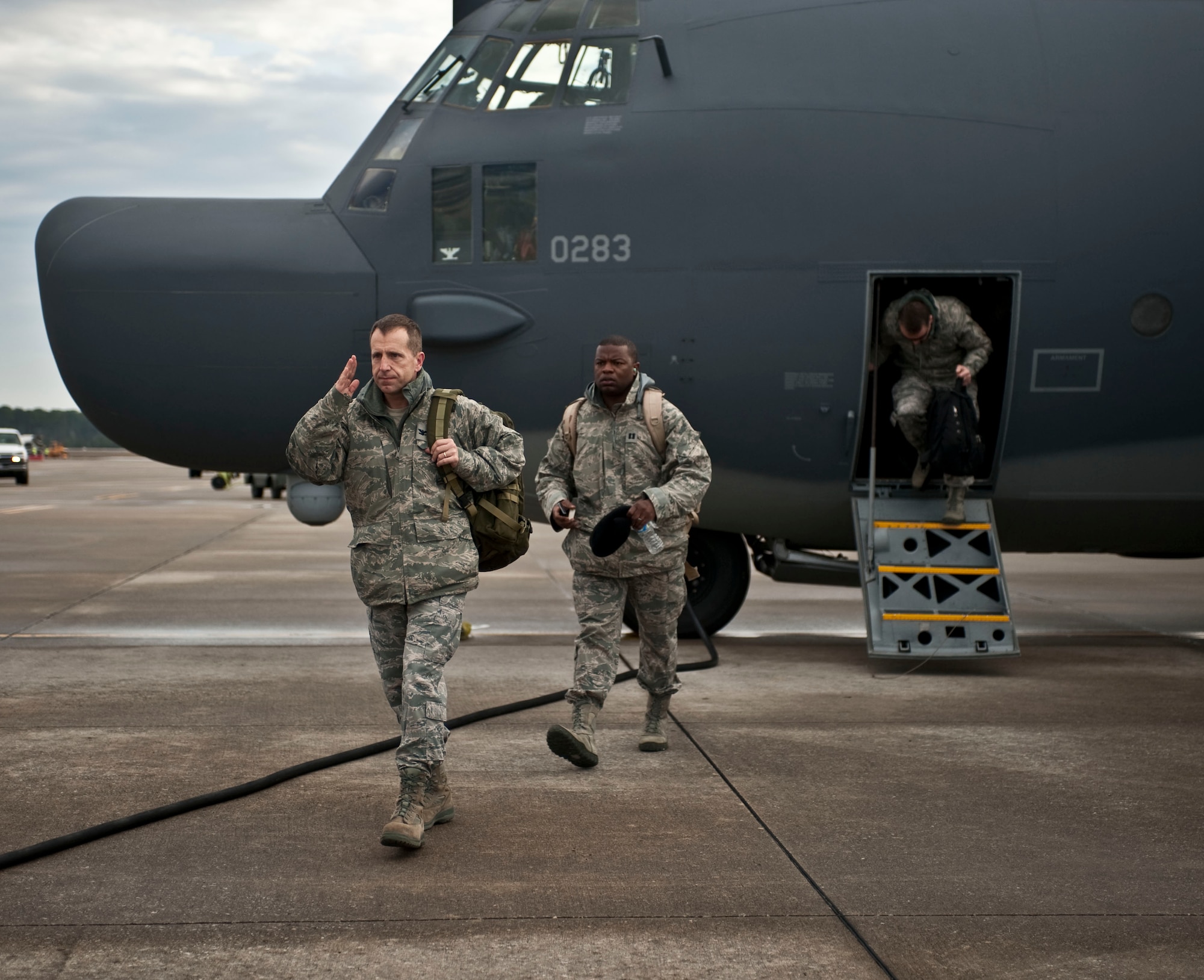 Col. Jim Slife, commander of 1st Special Operations Wing, disembarks from a Combat Talon II on the flightline at Hurlburt Field, Fla., Feb. 21, 2012. Capt. Myron Chivis, commander's executive of 1st SOW, follows the commander to his next location. (U.S. Air Force photo / Airman 1st Class Hayden Hyatt)