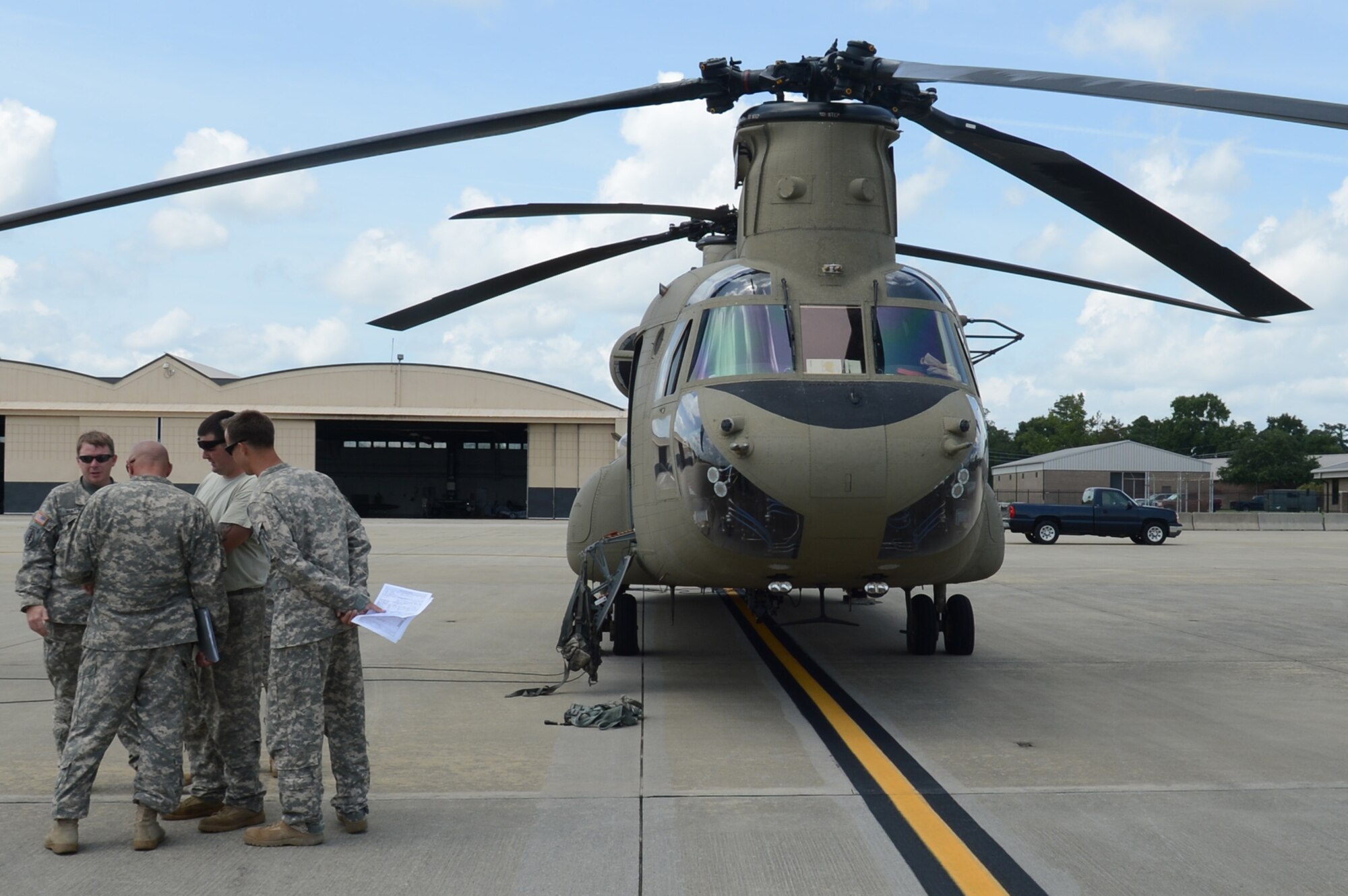 Soldiers from Company B, 3rd General Support Aviation Battalion, 82nd Combat Aviation Brigade, go over the flight plan before departing from Shaw Air Force Base, S.C., Aug. 9, 2013. These Soldiers fly the Boeing CH-47F Chinook helicopter which is powered by two turbo shaft engines that produce almost 5,000 horsepower. (U.S. Air Force photo by Airman 1st Class Jonathan Bass/Released)