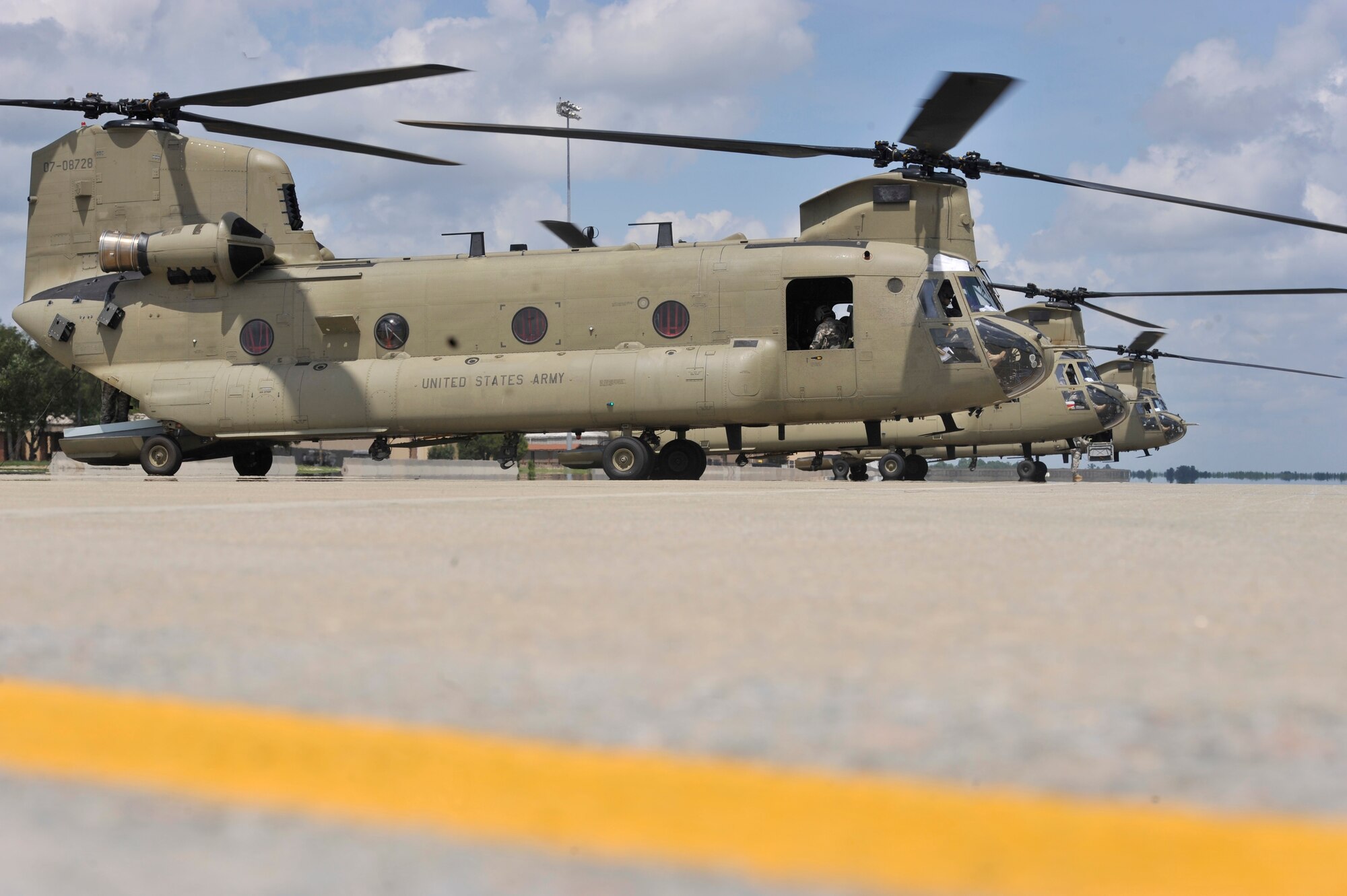 Three Army Boeing CH-47F Chinooks sit on the flightline waiting to depart from Shaw Air Force Base, S.C., Aug. 9, 2013. The Chinook can fly at speeds of 175 miles per hour and lift 21,000 pounds. (U.S. Air Force photo by Airman 1st Class Jonathan Bass/Released)