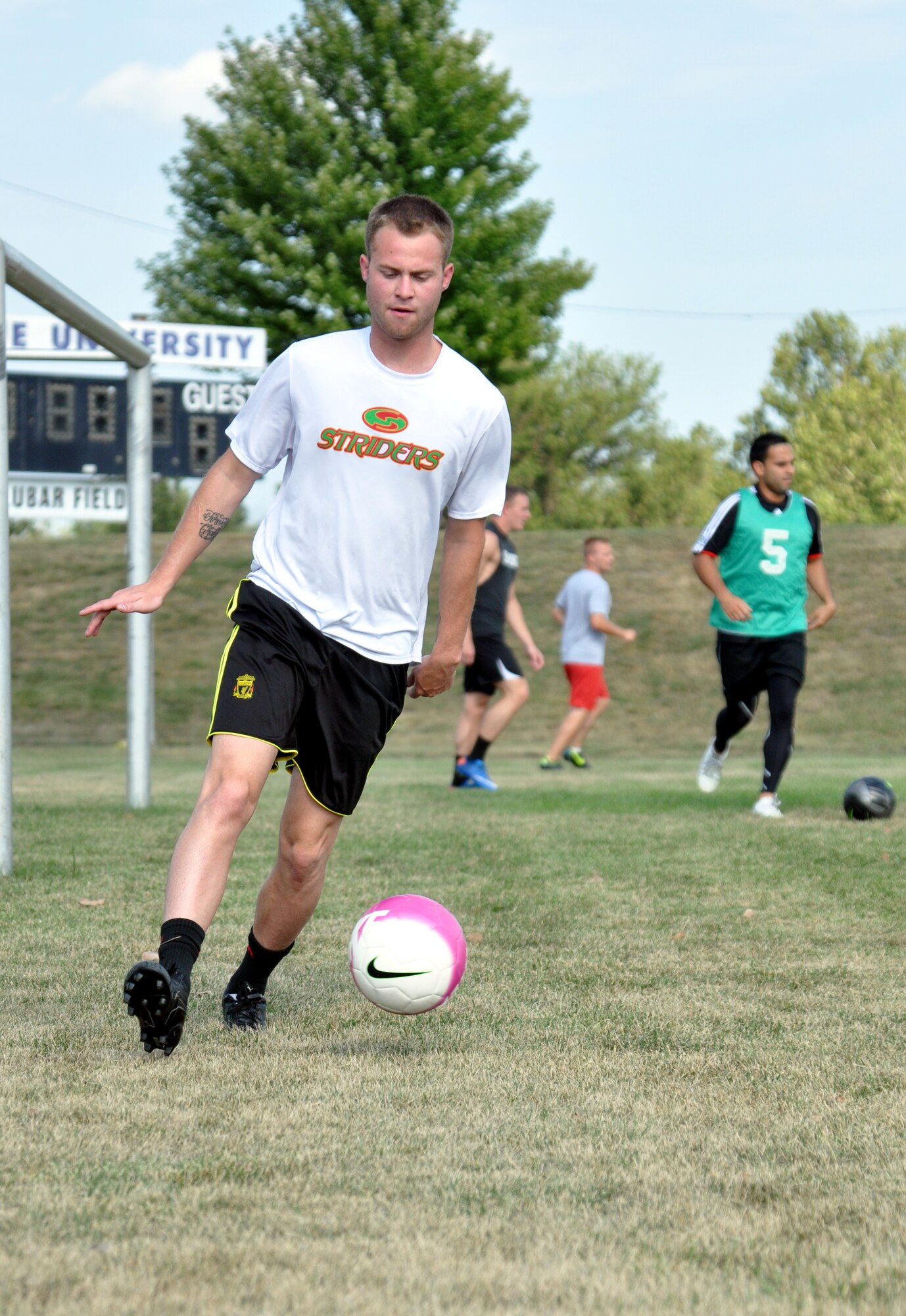 Alex Villers dribbles the ball during an FC Offutt practice Aug. 11 at Haworth Park in Bellevue, Neb. After going 0-3-1 in last year’s Defender’s Cup, the team hopes to improve on their performance over Labor Day at Lackland Air Force Base, Texas. (Photo by Ryan Hansen)