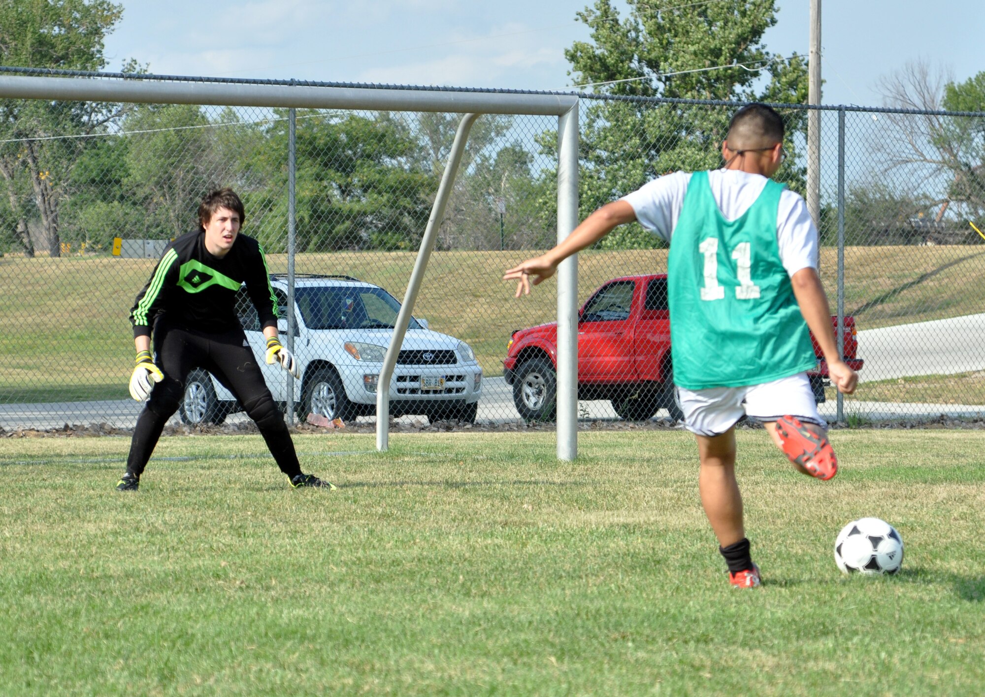 Jorge Arana, a U.S. Air Force senior Airman with the 55th Medical Support Squadron, fires a shot at goalkeeper Maxwell Piles during an FC Offutt practice Aug. 11 at Haworth Park in Bellevue, Neb. The club is headed to Lackland Air Force Base, Texas, for the second year in a row to play in the Defender's Cup, an annual military soccer tournament. (Photo by Ryan Hansen)