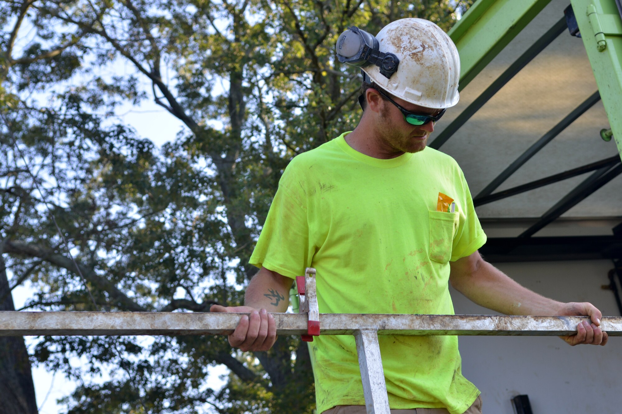 John Sousa, URS Corporation driller, connects safety railing onto the side of the drilling truck, Shaw Air Force Base, S.C., Aug. 12, 2013. Scheduled well maintenance will take place for the next two weeks on base.(U.S. Air Force photo by Airman 1st Class Ashley L. Gardner/Released)