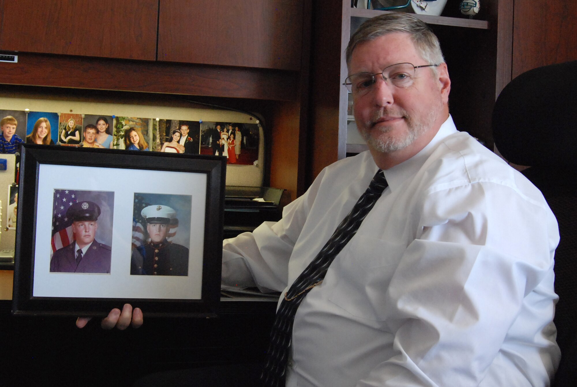 CHEYENNE MOUNTAIN AIR FORCE STATION, Colo. – Scott “Scooter” Deeds, 721st Security Forces Squadron Plans and Programs chief, holds a framed picture of his son’s boot camp graduation photo alongside his own photo from 1978. The Deeds family has a long line of military service stretching from the Civil War to today’s current operations. Deeds’ son, Lance Cpl. Roger Deeds, was killed while serving in Iraq with the 13th Marine Expeditionary Unit in 2005 and was the first member of their family to die in service. (U.S. Air Force photo/Michael Golembesky)