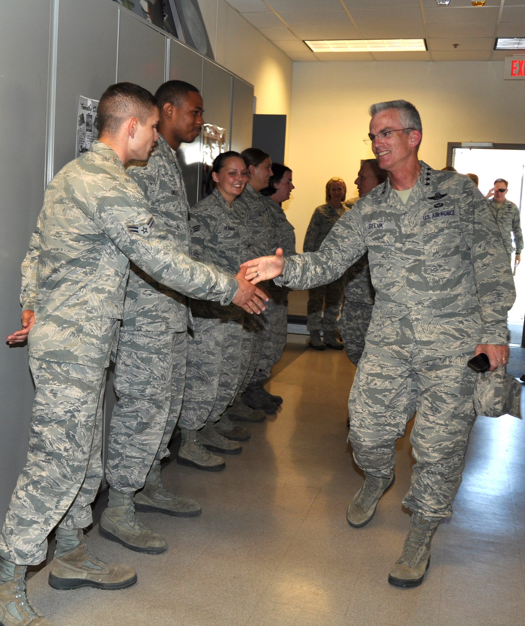 Gen. Paul Selva, Air Mobility commander greets Airman 1st Class Harlan Smith, 507th Aircraft Maintenance Squadron during joint visit to the 507th and 137th Air Refueling Wings, the first Reserve/Guard associated unit in the Air Force. During the visit the General met with Airmen, toured facilities and praised the citizen Airmen for their total force mission successes. (U.S. Air Force Photo/Lt. Col. Kimberly Howerton)