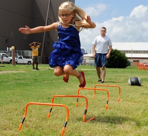 Anne Percivalle participates in an obstacle course during Operation Hero at Langley Air Force Base, Va., Aug. 7, 2013. The course was used to simulate the physical training test military members perform to remain eligible for deployment. (U.S. Air Force photo by Senior Airman Brittany Paerschke-O’Brien/Released)