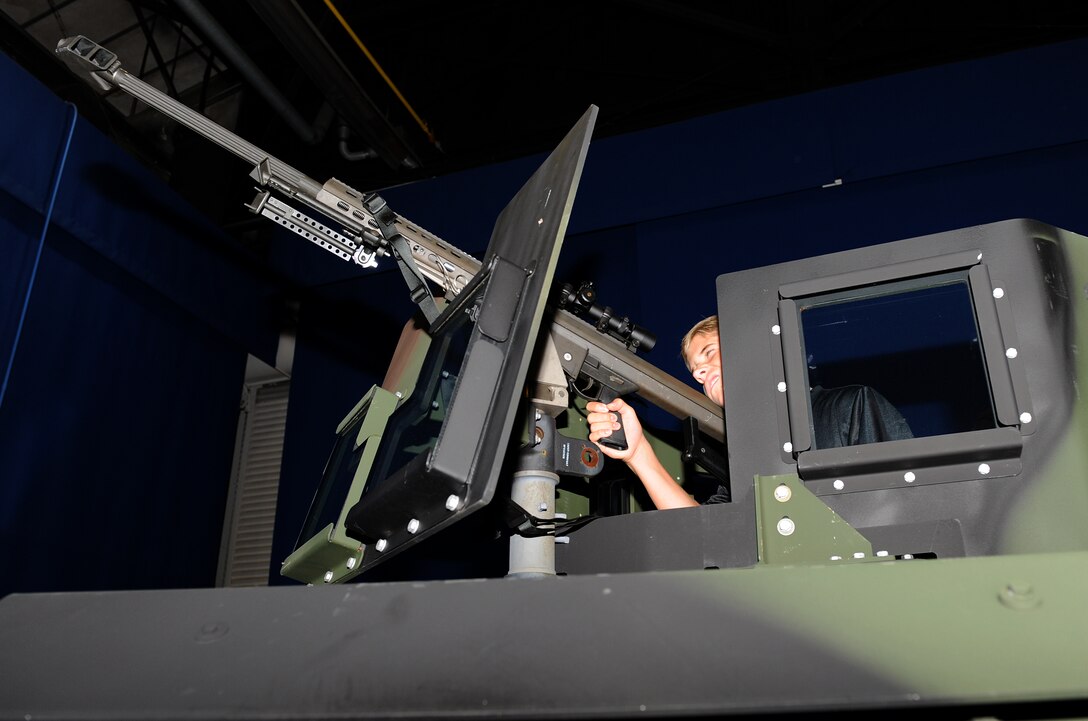 Tyler Percivalle simulates firing a .50-caliber M-107 sniper rifle out of a Humvee at the annual Operation Hero event at Langley Air Force Base, Va., Aug. 7, 2013. More than 280 children, families and volunteers participated in the day’s activities. (U.S. Air Force photo by Senior Airman Brittany Paerschke-O’Brien/Released) 