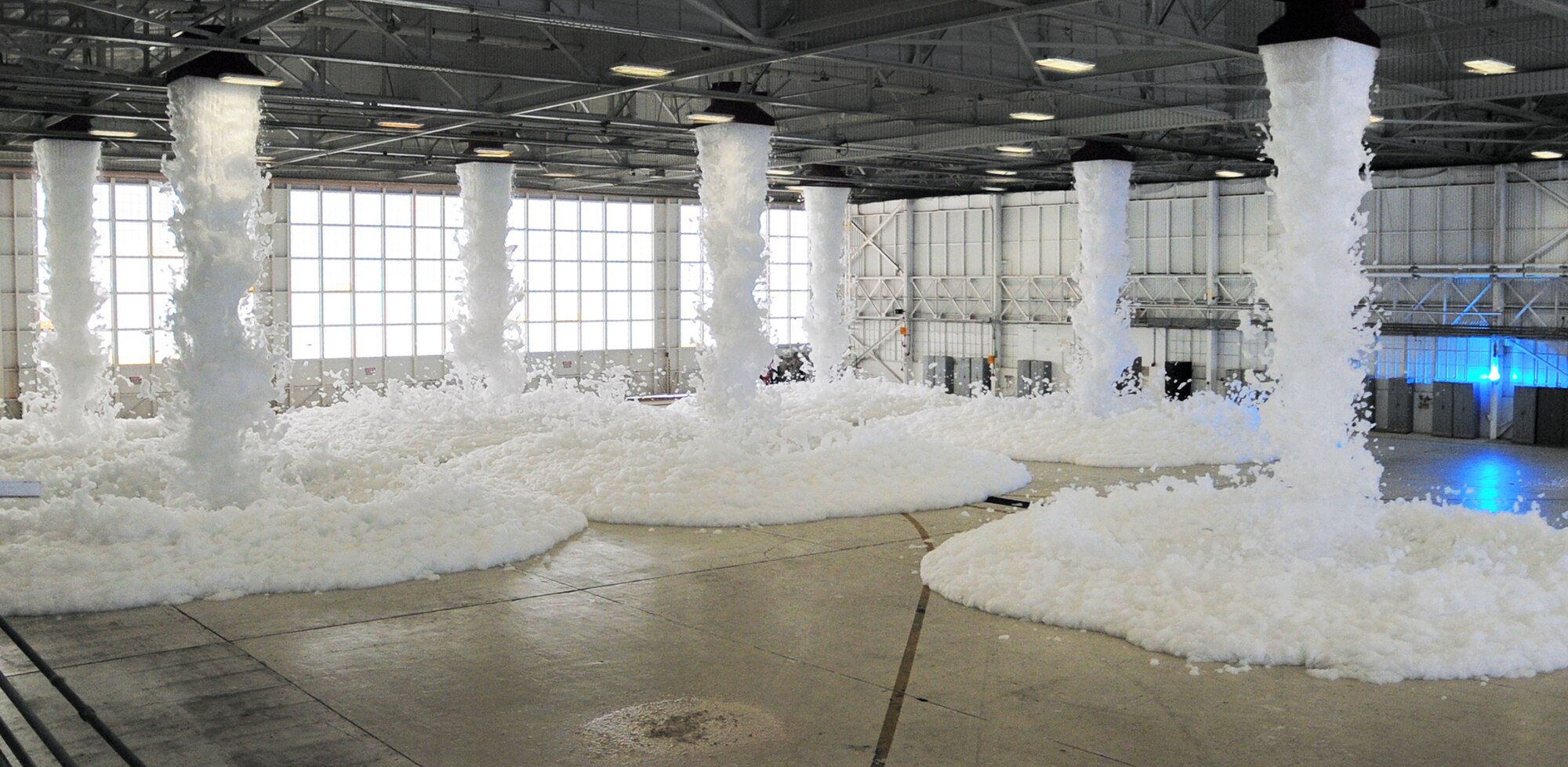 PATRICK AFB, Fla. -- The 920th Rescue Wing Maintenance Group tested one of its fire-suppression systems here today at 1 p.m. in Hangar 750. Pictured here, the system spews high-expansion foam from massive, fan-driven generators in the hangar ceiling. The foam is non-toxic and requires no clean up (it evaporates). According to Patrick AFB Assistant Fire Chief Dallas More, the system is capable of extinguising a fire in less than 30 seconds. (U.S. Air Force photo by Master Sgt. Paul Flipse)