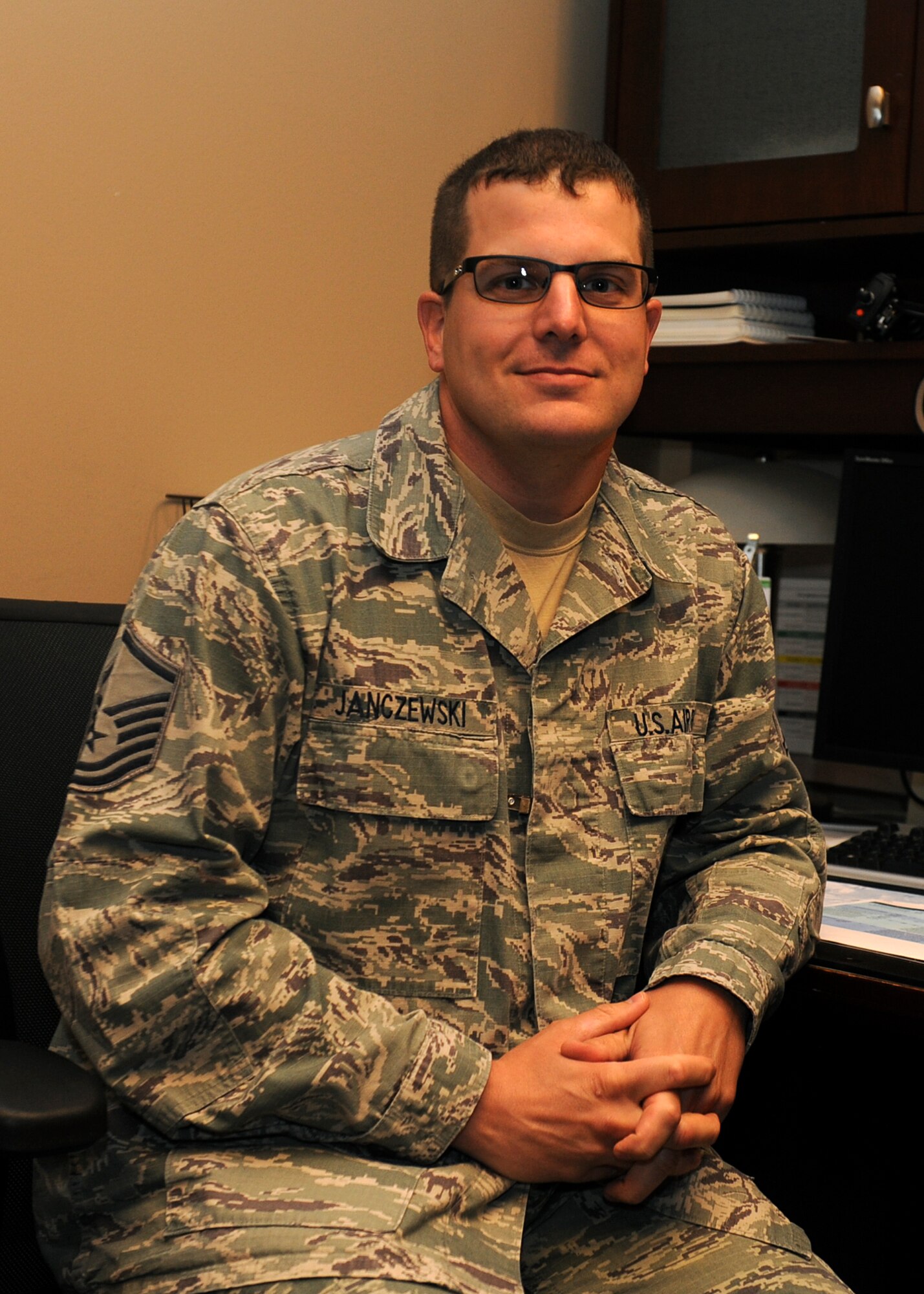 Master Sgt. William Janczewski II, the 19th Civil Engineering Squadron assistant chief of health and safety, poses during an interview after being named the 2013 Air Force Times Airman of the Year on Aug. 3, 2013 at Little Rock Air Force Base, Ark. Janczewski was awarded Airman of the Year for his quick actions during a fire while deployed to Afghanistan. (U.S. Air Force photo by Staff Sgt. Jessica Condit)