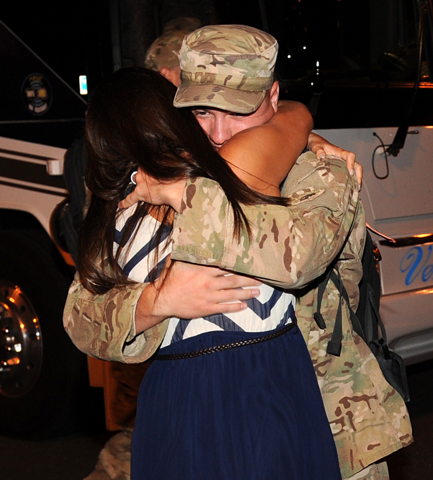 U.S Air Force Airman 1st Class Andrew James, 633rd Civil Engineer Squadron electrical systems journeyman, embraces a family member after returning from deployment at Langley Air Force Base, Va., Aug. 7, 2013. During deployment, James supported base construction and retrograded Army forward operating bases. (U.S. Air Force photo by Senior Airman Brittany Paerschke-O’Brien/Released)