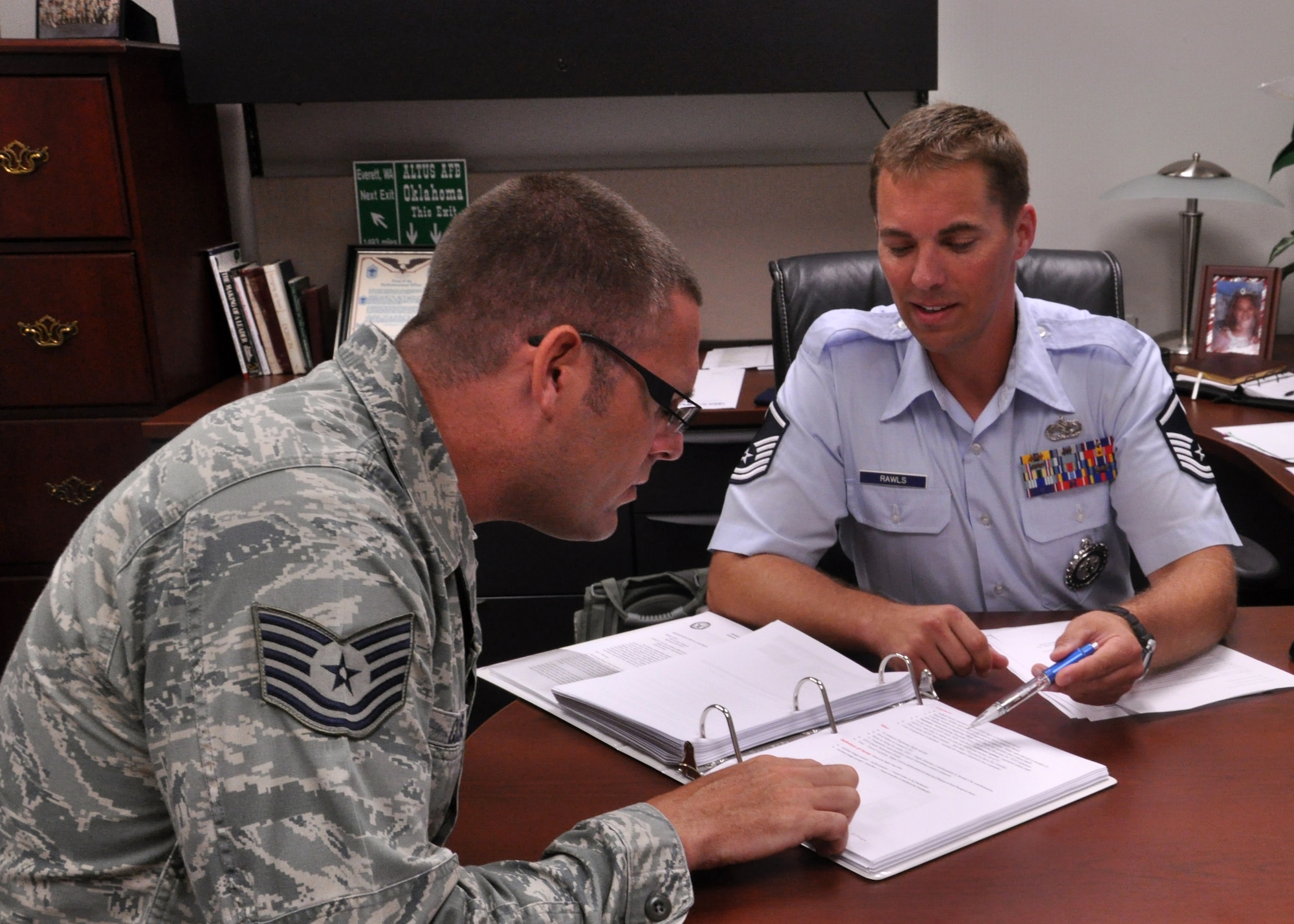 Master Sgt. Marcus Rawls, in-service Air National Guard recruiter, explains options in palace chasing to a Team Little Rock member July 31. Rawls is the first permanent recruiter for Little Rock Air Force Base. (U.S. Air Force photo by Senior Airman Regina  Agoha)