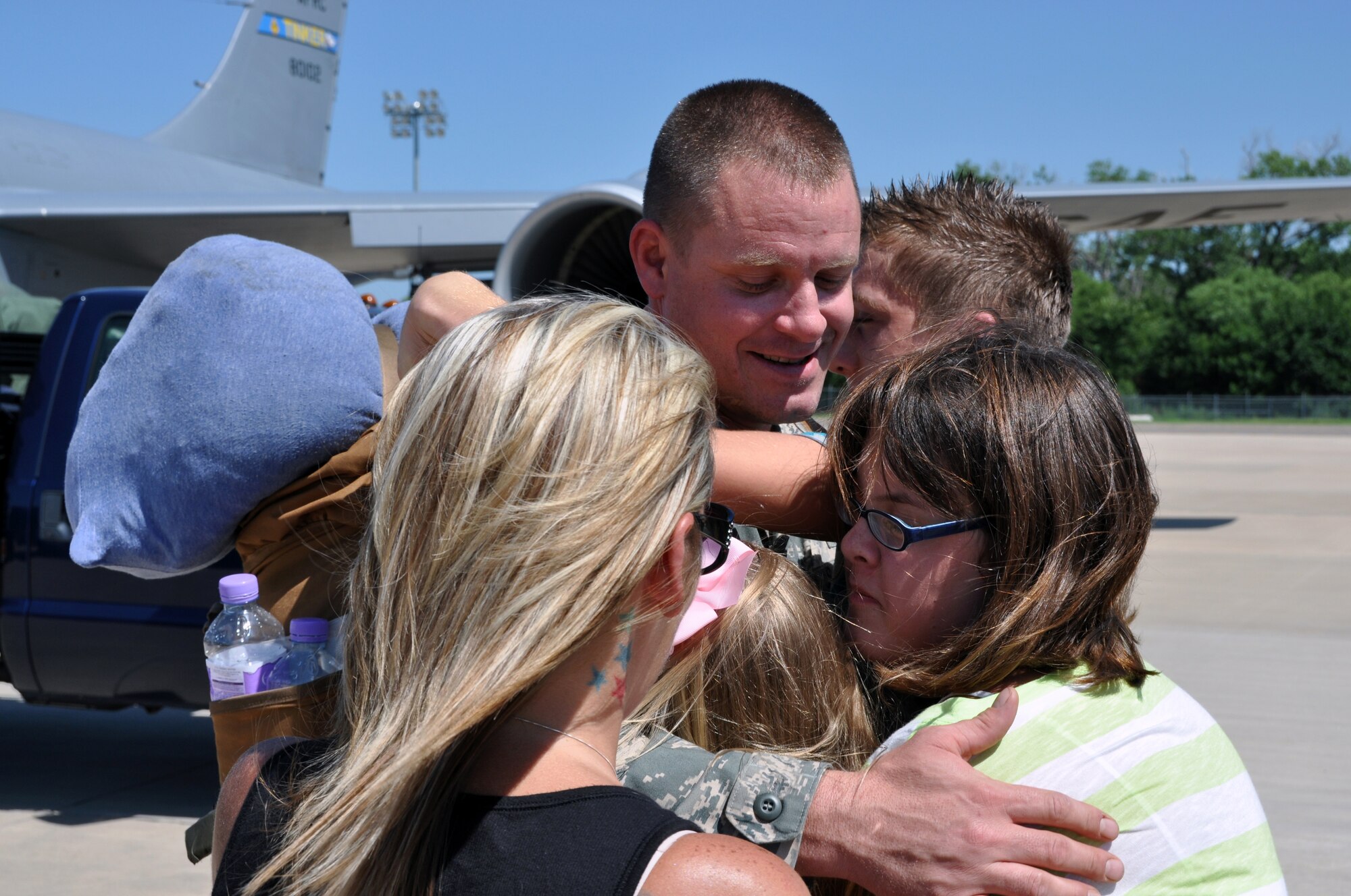 Staff Sgt. Anthony Welden receives huge welcome home hugs and tears from wife and children after returning home from Southwest Asia Tuesday Aug. 6.  Welden and about 13 other members from the 137th Air Refueling Wing, Oklahoma Air National Guard spent nearly 70 days overseas in support of combat operations.  Returning members were not only greeted by loved ones, but also by Gen. Paul J. Selva, commander, Air Mobility Command and Maj. Gen. Myles L. Deering, the adjunct general, Oklahoma National Guard.  After being thanked for their efforts, they were cut loose to go spend well-needed time with family and friends. (U.S. Air Force Photo/Senior Airman Mark Hybers) 