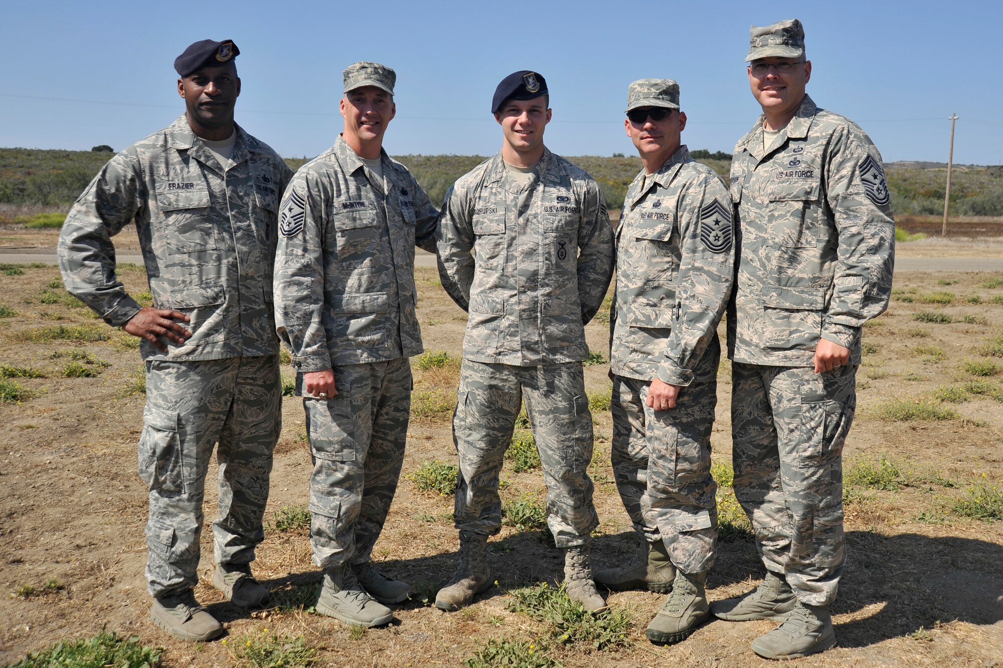 130731-F-IN231-163.JPG || VANDENBERG AIR FORCE BASE, Calif. -- Chief Master Sgt. Anthony Frazier, 30th Security Forces Squadron manager, Chief Master Sgt. Douglas McIntyre, Air Force Space Command command chief, Chief Master Sgt. Patrick McMahon, 14th Air Force command chief, and Chief Master Sgt. Ryan Peterson, 30th Space Wing command chief, stand with Senior Airman Alexander Skorupski, 30 SFS member and Outstanding Airman representative, after offering their congratulations during a tour by McIntyre here Wednesday, July 31. (U.S. Air Force photo/Michael Peterson)