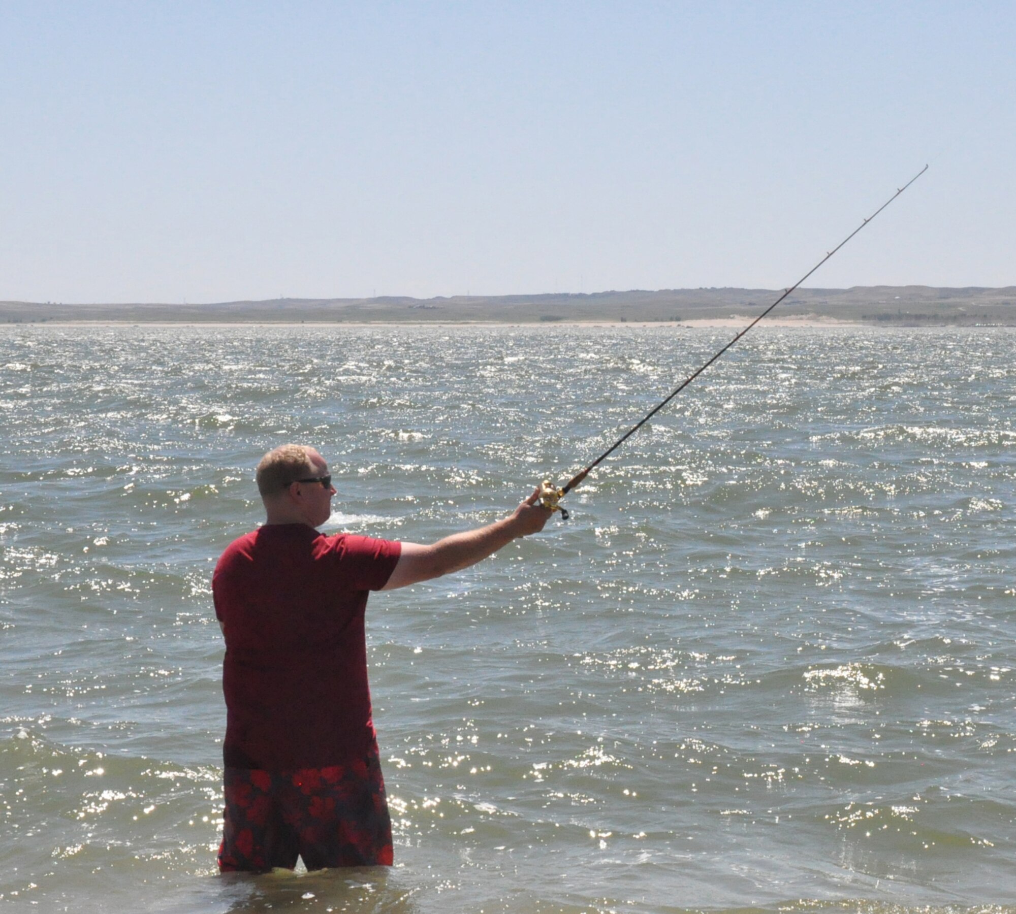 130810-F-GZ967-145 Shane Black casts a line into Lake McConaughy, Neb., while relaxing on the north side of the lake Aug. 10, 2013. Black was a volunteer chaperone for the Single Airman Adventure program during Outdoor Recreation’s weekend trip to the lake. (U.S. Air Force Photo by Airman 1st Class Brandon Valle)