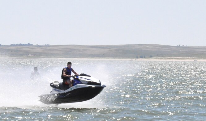 130810-F-GZ967-122 Tyler Young rides across Lake McConaughy, Neb., Aug. 10, 2013 during a weekend trip to the lake. Young was able to ride Jet Skis and enjoy a weekend trip out to the lake due to the efforts of Outdoor Recreation and their Single Airmen Adventure program. (U.S. Air Force Photo by Airman 1st Class Brandon Valle)