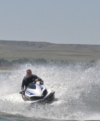 130810-F-GZ967-110 Anthony Raas shows off his Jet Ski skills on Lake McConaughy, Neb., Aug 10, 2013 as he maneuvers the Jet Ski in a sharp turn causing a wave of water to cast out behind him. Raas was at the Lake during an Outdoor Recreation weekend trip for Airmen.  (U.S. Air Force Photo by Airman 1st Class Brandon Valle)