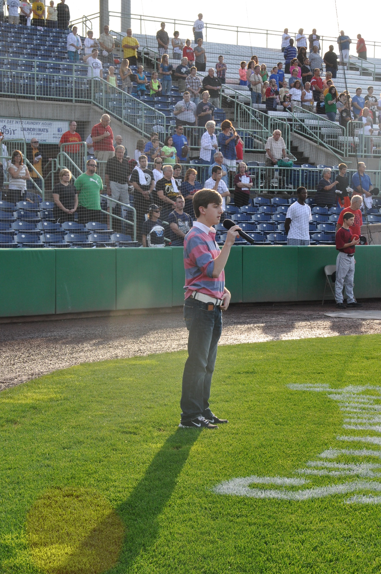 Eoin Rude, a senior at St Thomas Aquinas High School in Louisville, Ohio and son of Master Sgt. John Rude, Unit Training Manager for the 910th Airlift Wing’s 76th Aerial Port Squadron, sings the National Anthem during a minor league baseball game between the Cleveland Indians Class A affiliate Mahoning Valley Scrappers and the Lowell Spinners at Eastwood Field here, August 7, 2013. Nearly 200 Citizen Airmen along with their families, friends and co-workers were in attendance and representatives from the 910th, based at nearby Youngstown Air Reserve Station, Ohio, were involved in many game night activities. U.S. Air Force photo by Master Sgt. Bob Barko Jr.