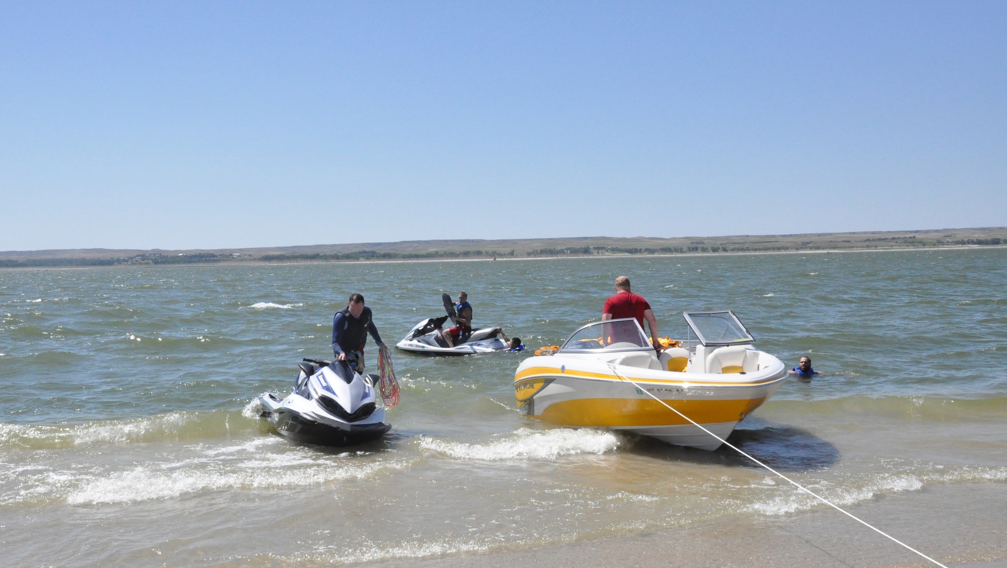 130810-F-GZ967-092 Anthony Raas, Solomon Raas, Shane Black, Lance Choltko, and Kyle Holt beach the watercraft as they prepare to spend some time relaxing on the beach on the north side of Lake McConaughy, Neb., Aug. 10, 2013. The group was at the lake participating in an Outdoor Recreation sponsored weekend trip for Airmen. (U.S. Air Force Photo by Airman 1st Class Brandon Valle)