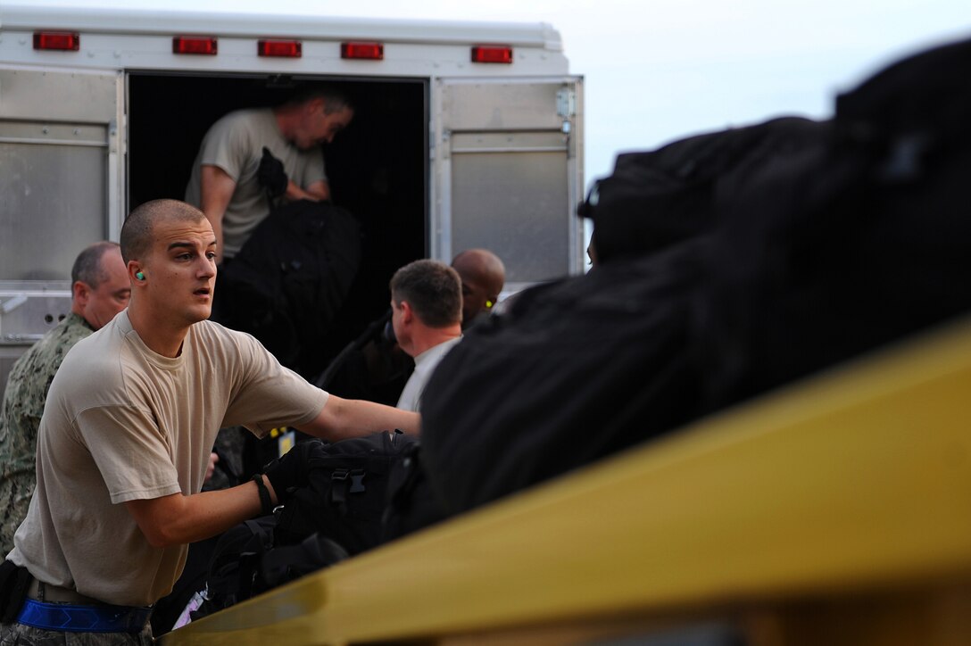 U.S. Air Force Staff Sgt. Craig Grabowski, 633rd Logistics Readiness Squadron air terminal supervisor, loads luggage onto an aircraft at Langley Air Force Base, Va., Aug. 11, 2013. The aircraft took Joint Task Force Civil Support members to Vibrant Response 13-2, a major joint field training at Camp Atterbury, Ind. (U.S. Air Force Photo by Airman 1st Class Kimberly Nagle/Released)