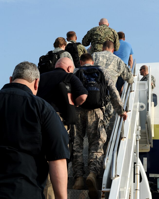 Joint Task Force Civil Support personnel board an aircraft bound for a deployment at Langley Air Force Base, Va., Aug. 11, 2013. JTF-CS personnel deployed to Camp Atterbury, Ind. to participate in Vibrant Response 13-2, a major joint field training exercise. (U.S. Air Force Photo by Airman 1st Class Kimberly Nagle/Released)