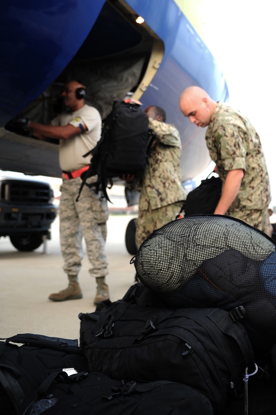 Joint Task Force Civil Support Service members, from Fort Eustis, Va., load cargo onto an aircraft at Langley Air Force Base, Va., Aug. 11, 2013. The JTF-CS deployed to Camp Atterbury, Ind. for a major joint field training exercise. (U.S. Air Force Photo by Airman 1st Class Kimberly Nagle/Released) 