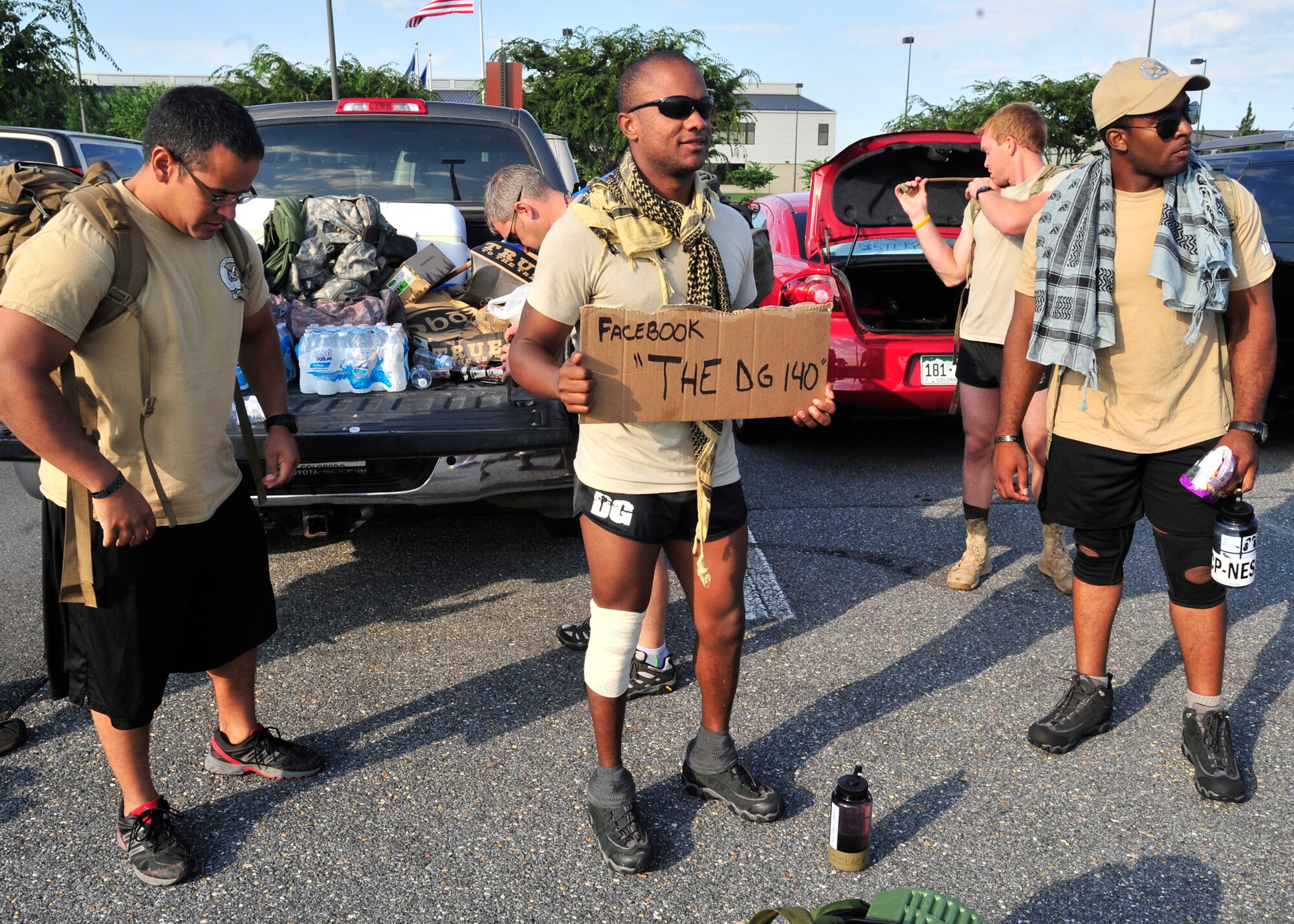 Staff Sgt. Joseph Gilbert, 13th Air Support Operations Squadron, holds a sign before they set off on memorial ruck march to Arlington National Cemetery Aug. 4, 2013, at Dover Air Force Base, Del. The ruck march was in honor of Maj. David Gray, who was killed Aug. 8, 2012, in Afghanistan. (U.S. Air Force photo/Tech. Sgt. Chuck Walker)