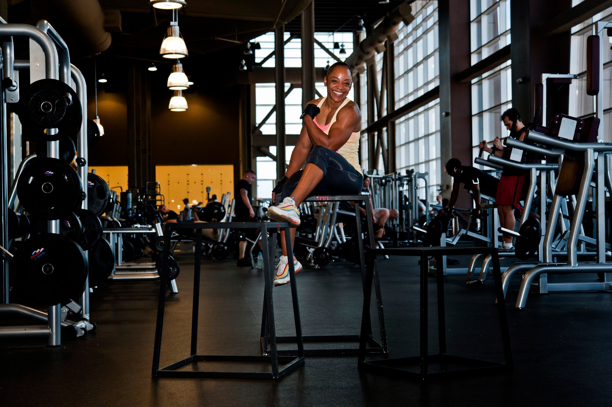 U.S. Air Force Staff Sgt. Victoria Dean, 57th Aircraft Maintenance Squadron unit fitness program manager, sits on fitness boxes and flexes at the Warrior Fitness Center Aug. 2, 2013, at Nellis Air Force Base, Nev. Dean is nominated for Nellis Female Athlete of the Year, and her next goal is to compete Sept. 7, in the National Armed Forces Natural Bodybuilding Championship. (U.S. Air Force photo by Senior Airman Daniel Hughes)