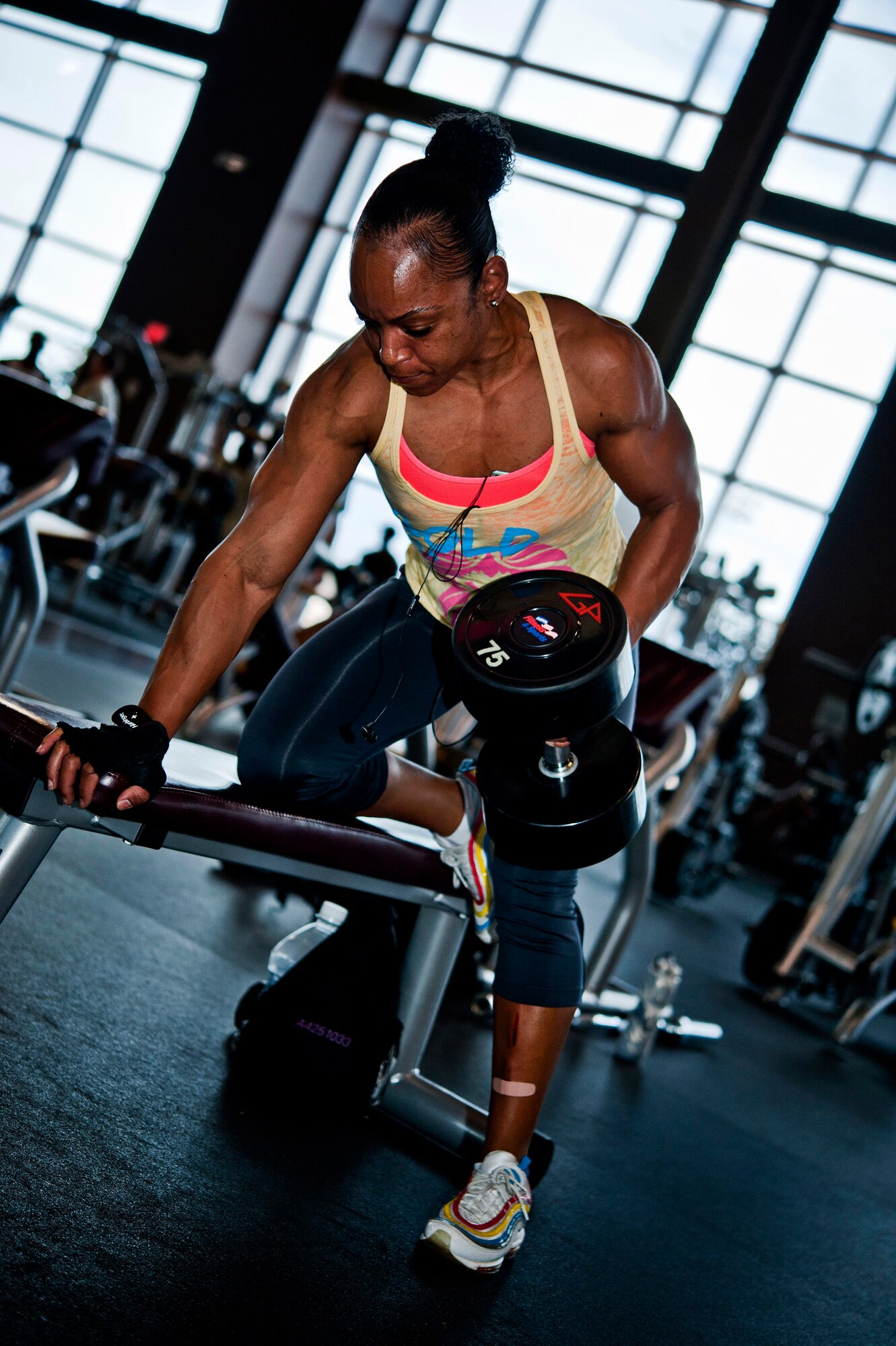U.S. Air Force Staff Sgt. Victoria Dean, 57th Aircraft Maintenance Squadron unit fitness program manager, lifts a 75 pound dumbbell during a strength workout at the Warrior Fitness Center Aug. 2, 2013, at Nellis Air Force Base, Nev. Dean has competed in and won three military body building competitions. (U.S. Air Force photo by Senior Airman Daniel Hughes)