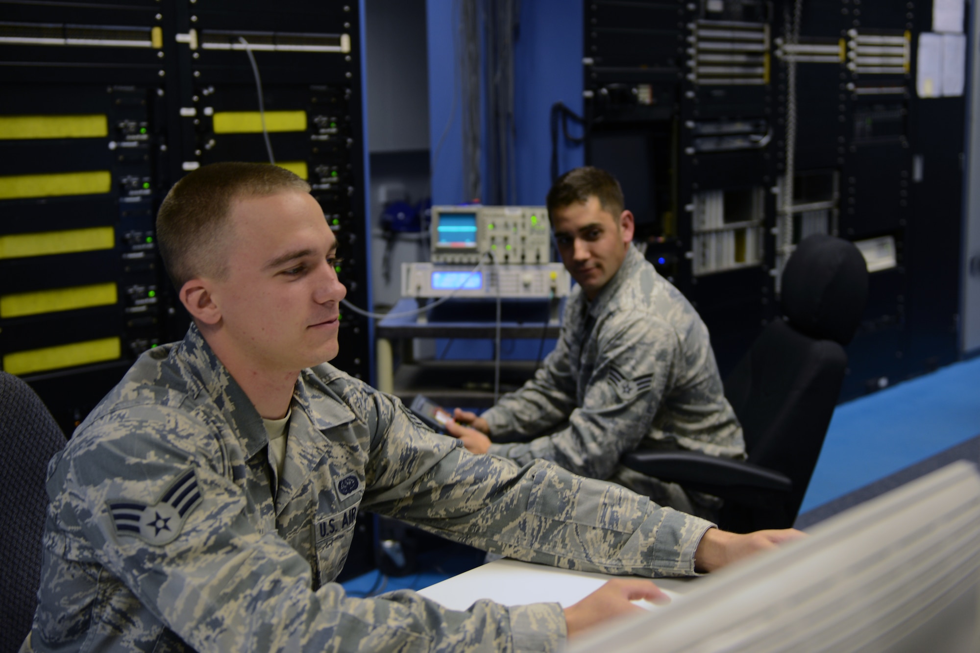 RAF CROUGHTON, United Kingdom – Senior Airmen Brandon Raona (right) and Baron Billingsley, 422nd Communications Squadron radio frequency transmission journeymen, measure output levels to ensure they are in tolerance. (U.S. Air Force photo by Tech. Sgt. Chrissy Best)