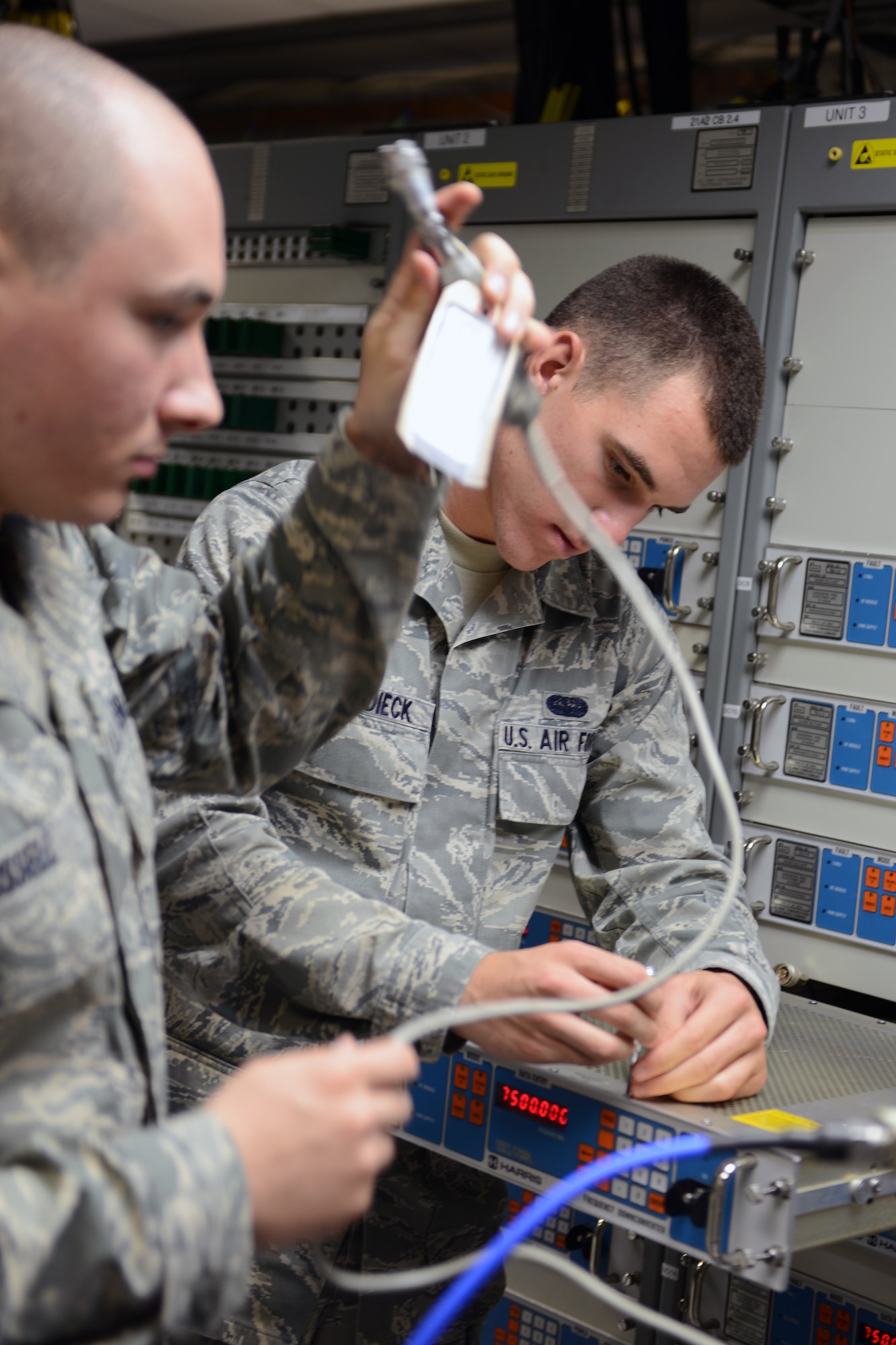 RAF CROUGHTON, United Kingdom – Senior Airman Sean Russell (left) and Airman 1st Class Darren Dierck, 422nd Communications Squadron radio frequency transmission technicians, prepare to align a satellite to the modem inside Building 180. (U.S. Air Force photo by Tech. Sgt. Chrissy Best)