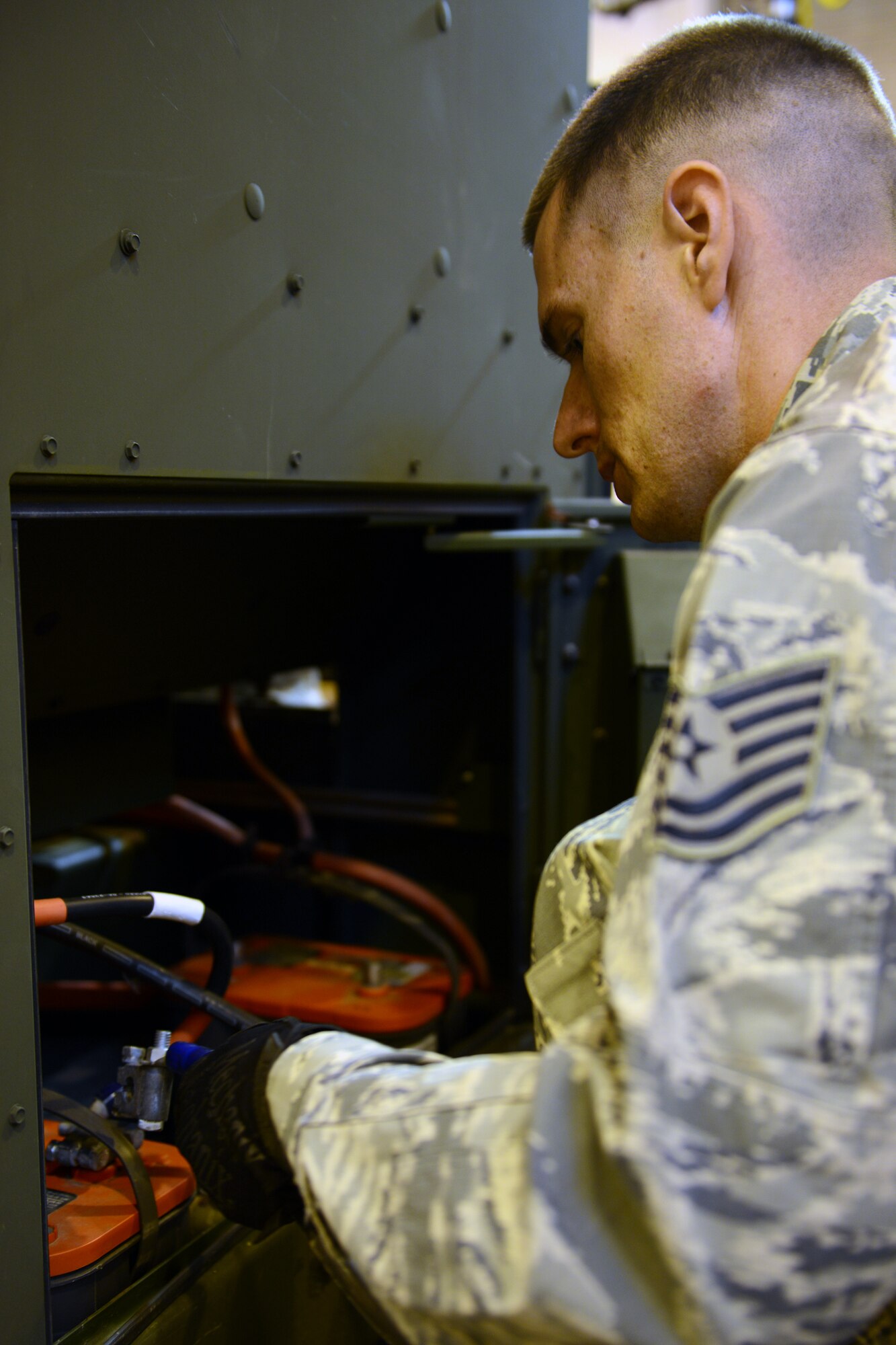 RAF CROUGHTON, United Kingdom – Tech. Sgt. Whitney Hancock, 422nd Civil Engineer Squadron power pro shop, disconnects the battery cables on a generator. The power pro shop was doing maintenance on the generator after being outside for an Armed Forces Entertainment event. (U.S. Air Force photo by Tech. Sgt. Chrissy Best)