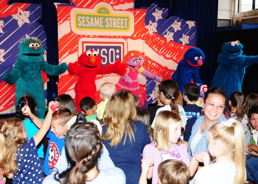Rosita, Elmo, Katie, Grover and Cookie Monster sing and dance for the audience at the Sesame Street/United Services Organization Experience for Military Families Aug. 12, 2013, in the North Side Fitness Center on RAF Mildenhall, England. The Sesame Street characters gave two performances for children as part of the tour of military bases. More than 1,100 people attended the event. (U.S. Air Force photo by Karen Abeyasekere/Released)